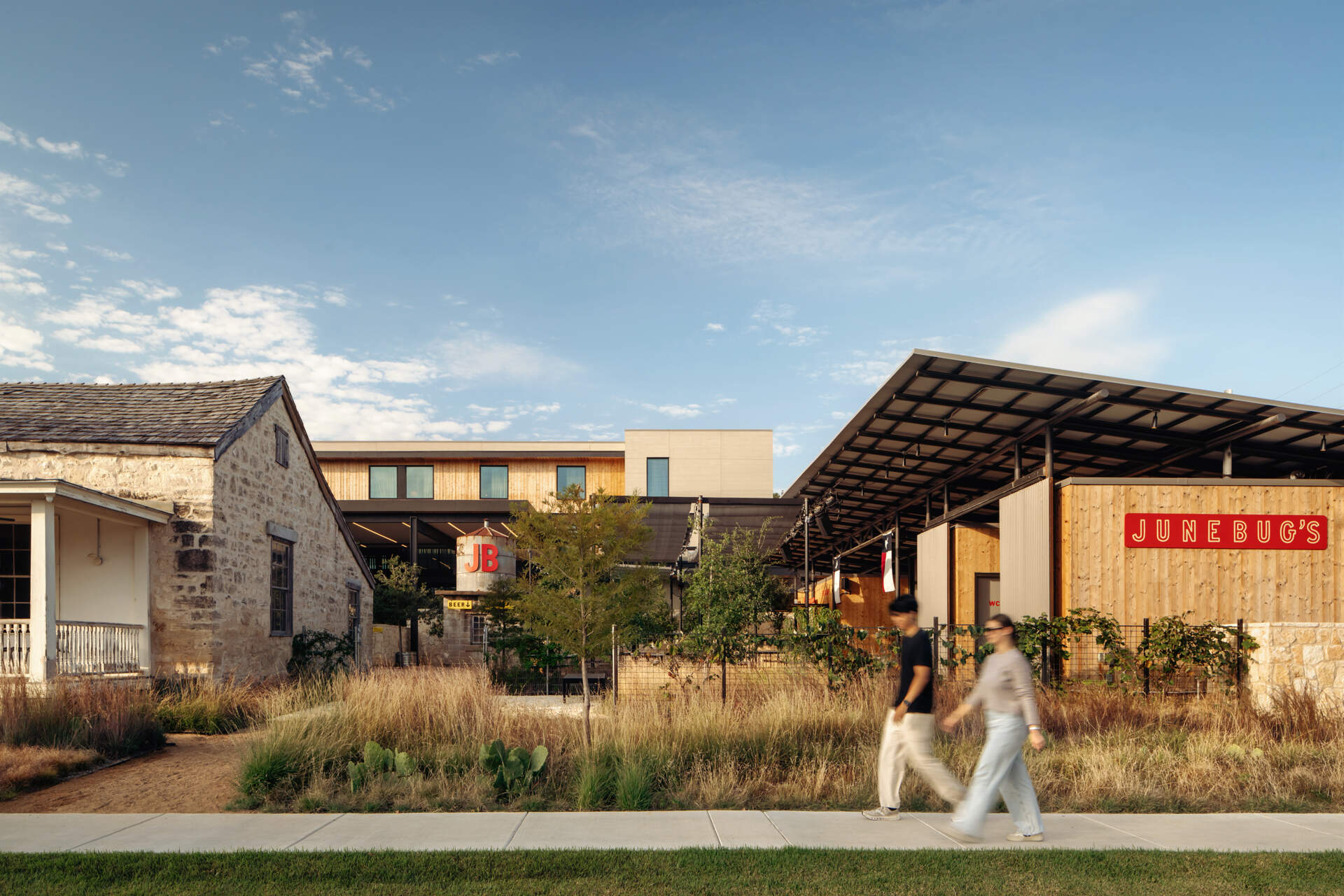 A two acre hotel property organized around gardens, paths, and outdoor connections rather than enclosed corridors.