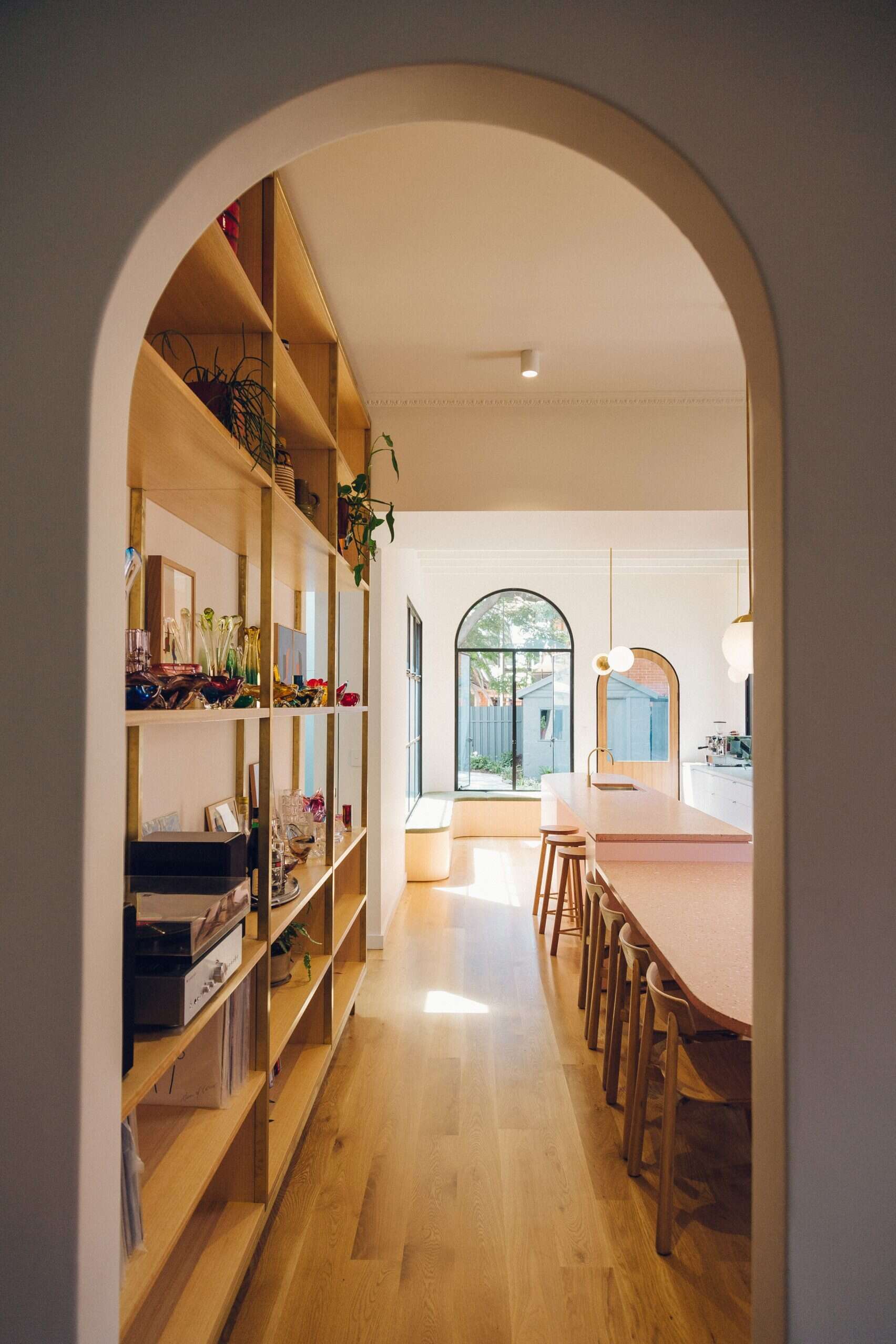 An arched doorway links the new addition to the original cottage, blending old and new with ease.
