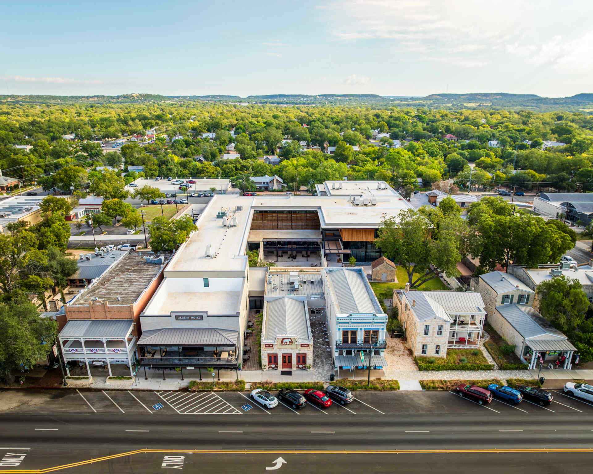 Historic streetfront buildings remain intact while new hotel architecture is quietly positioned behind, preserving the rhythm of downtown Fredericksburg.