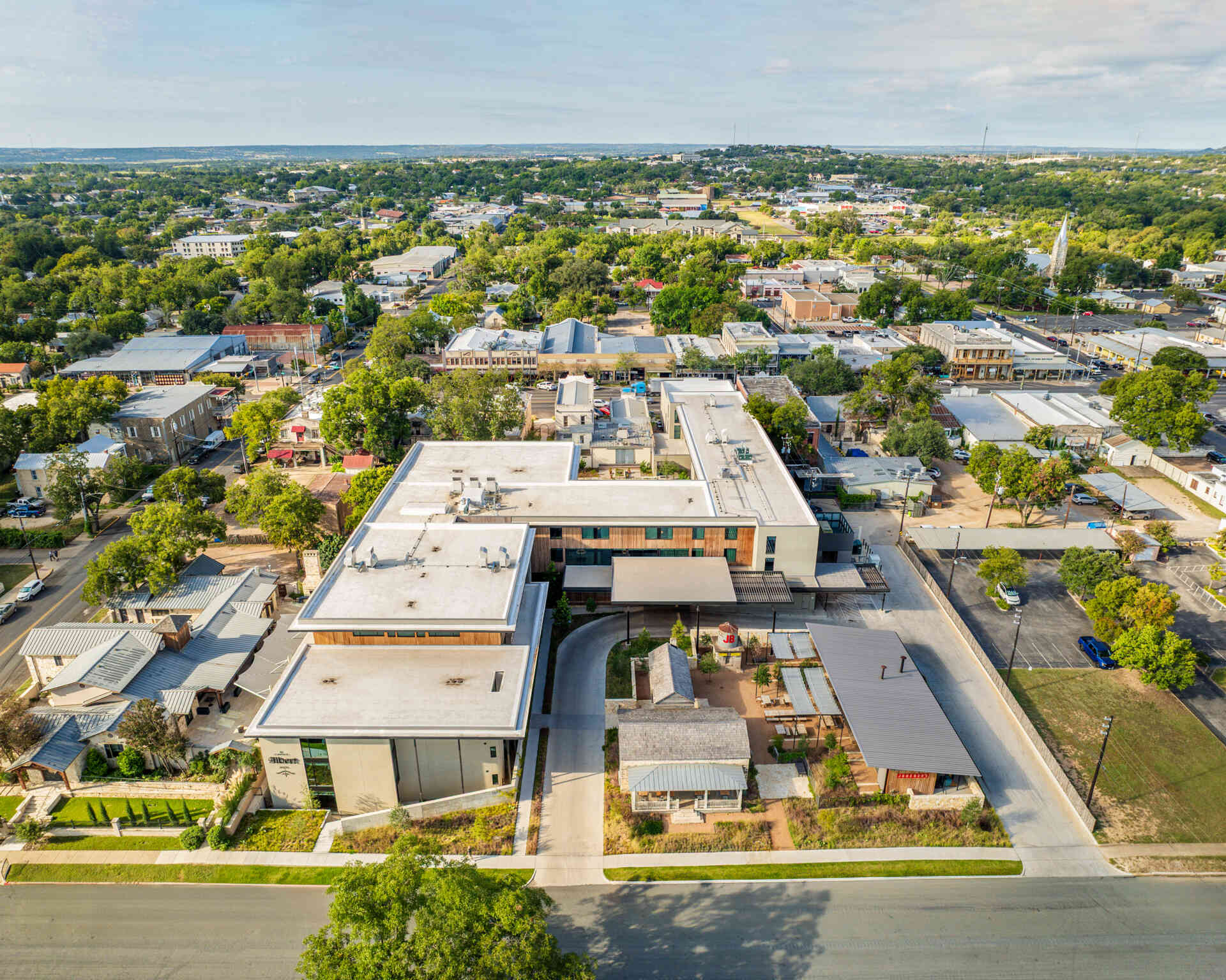 Historic streetfront buildings remain intact while new hotel architecture is quietly positioned behind, preserving the rhythm of downtown Fredericksburg.
