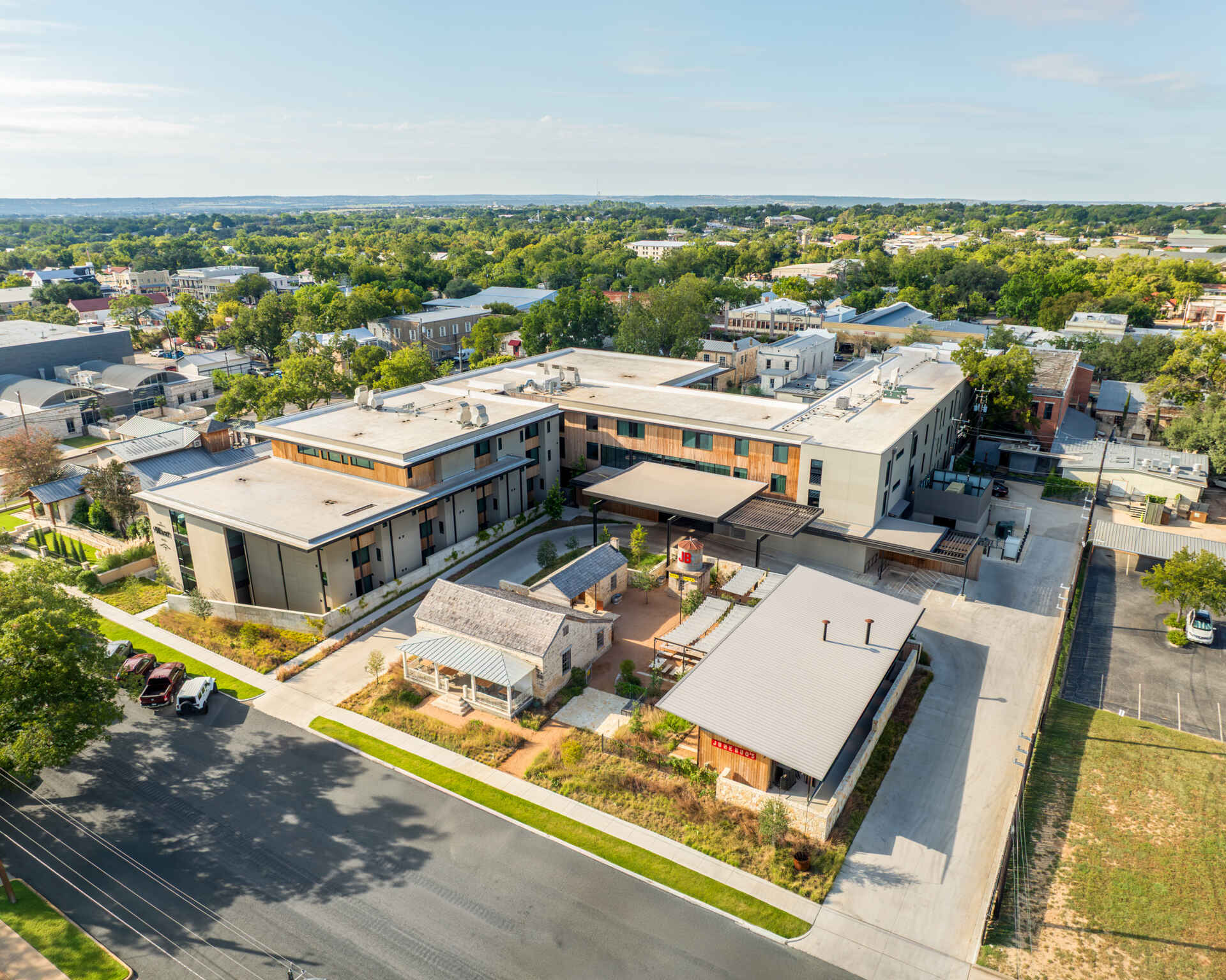 Historic streetfront buildings remain intact while new hotel architecture is quietly positioned behind, preserving the rhythm of downtown Fredericksburg.