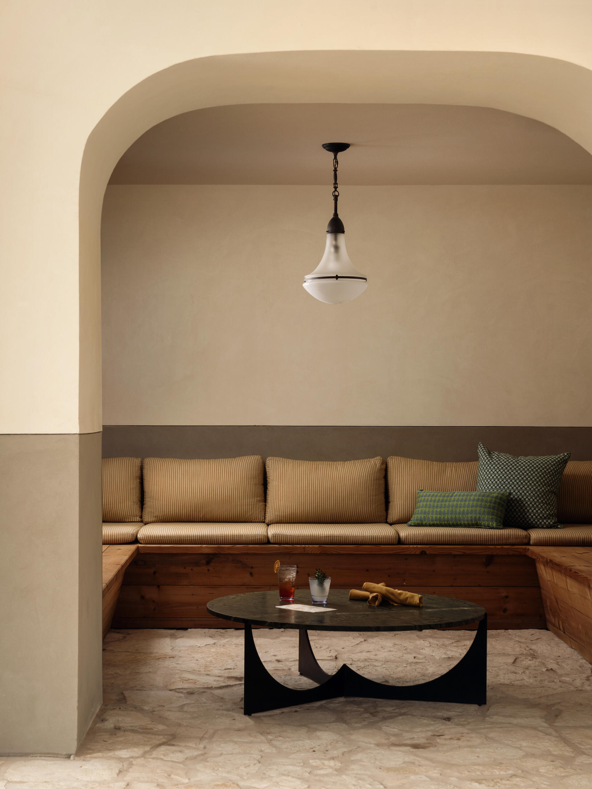 Built in seating and an arched nook offer places to pause with a drink