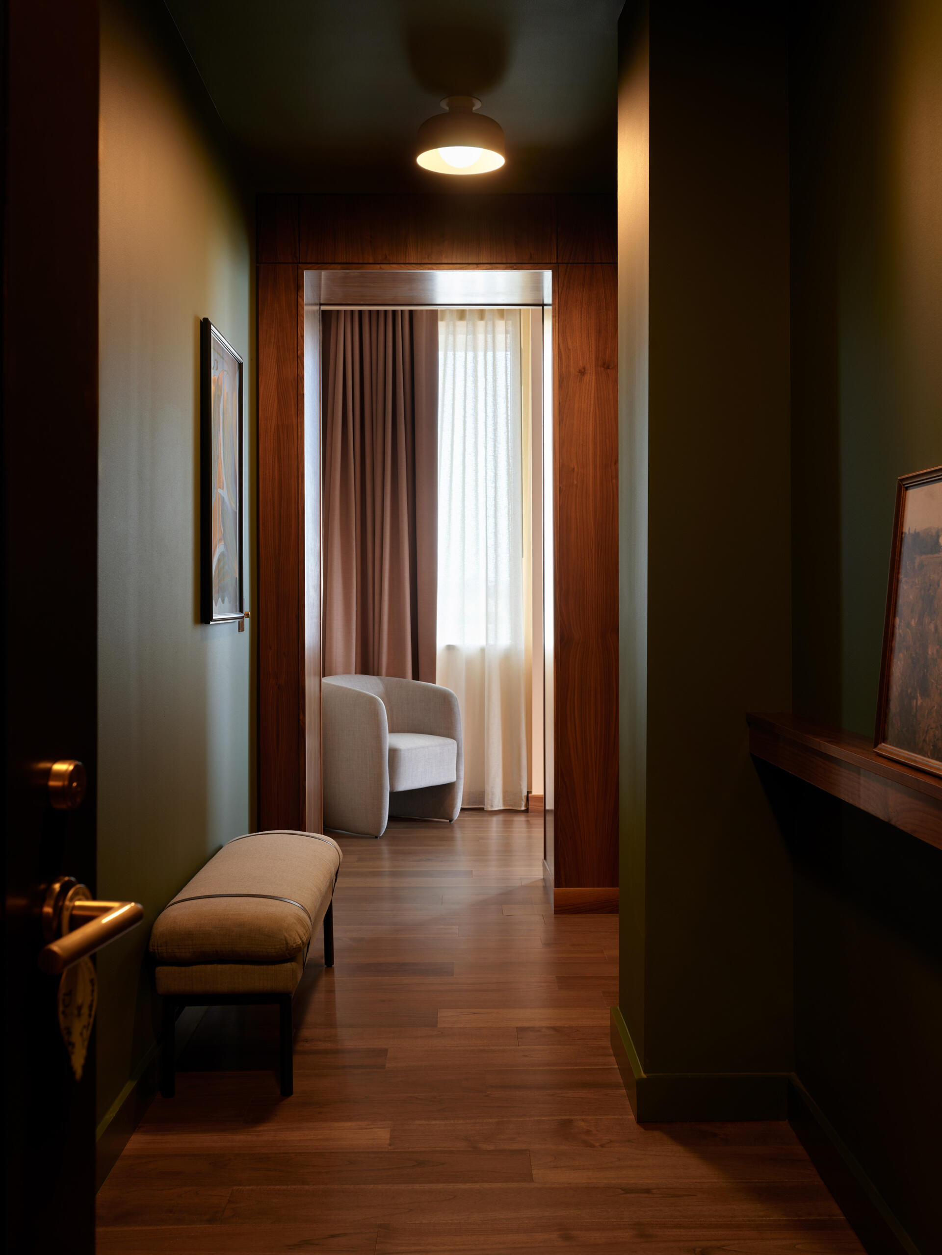 Hotel guest rooms and bathrooms blend Nordic modern influences with terrazzo floors, curved details, custom millwork, and integrated bar setups.