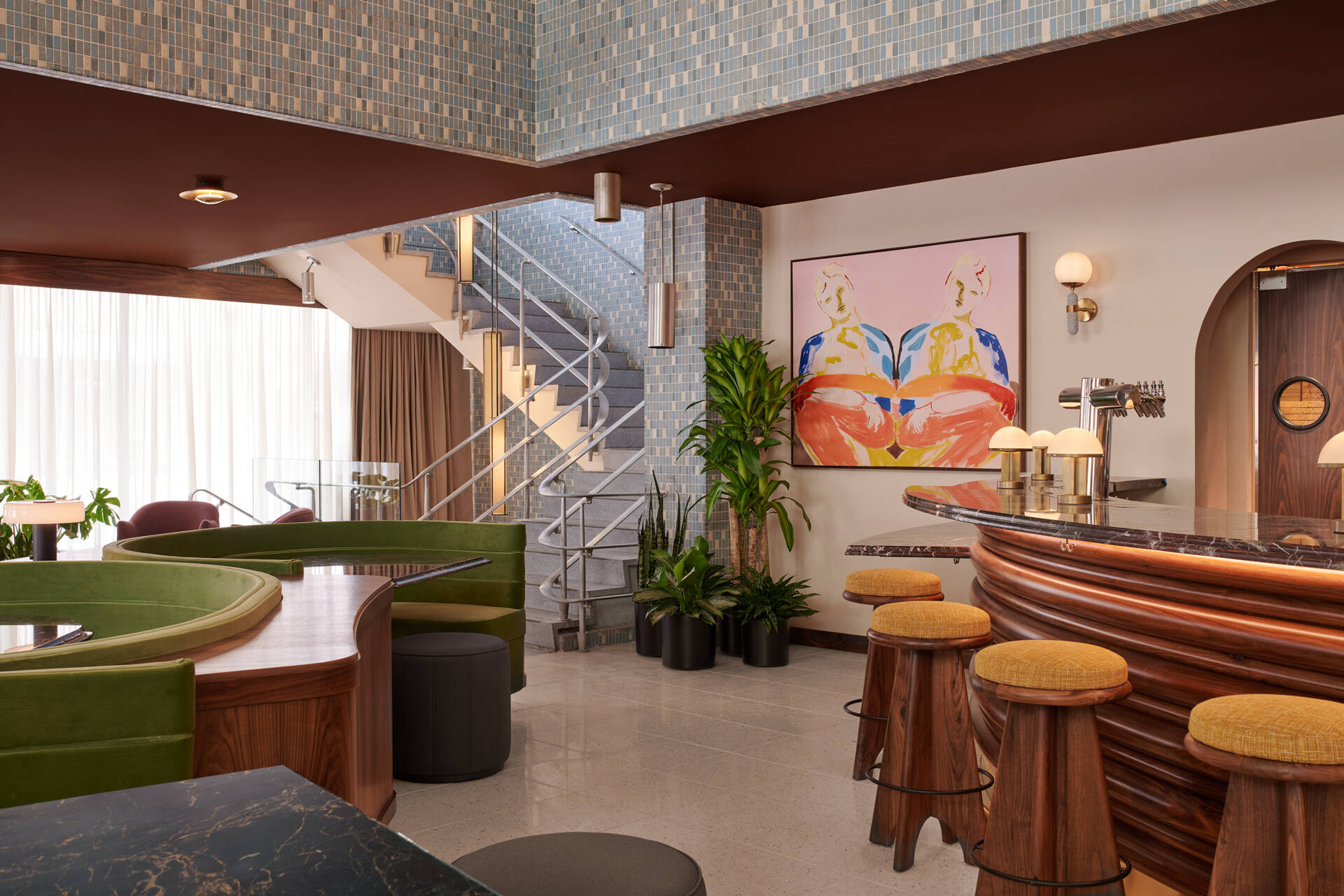 In this hotel, original staircases connect the lobby, mezzanine, and basement, maintaining the building’s historic circulation patterns while guiding guests through layered experiences.