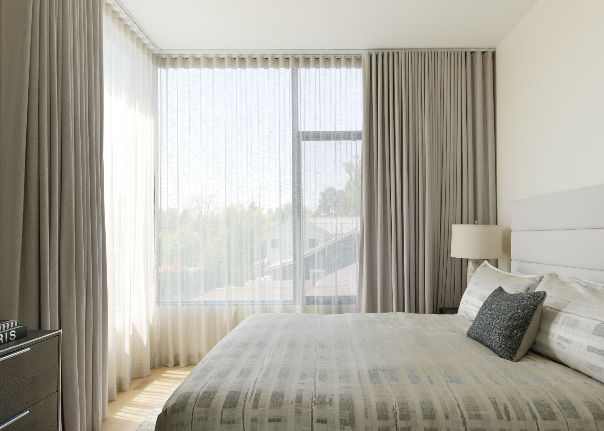 A contemporary bedroom with neutral finishes.