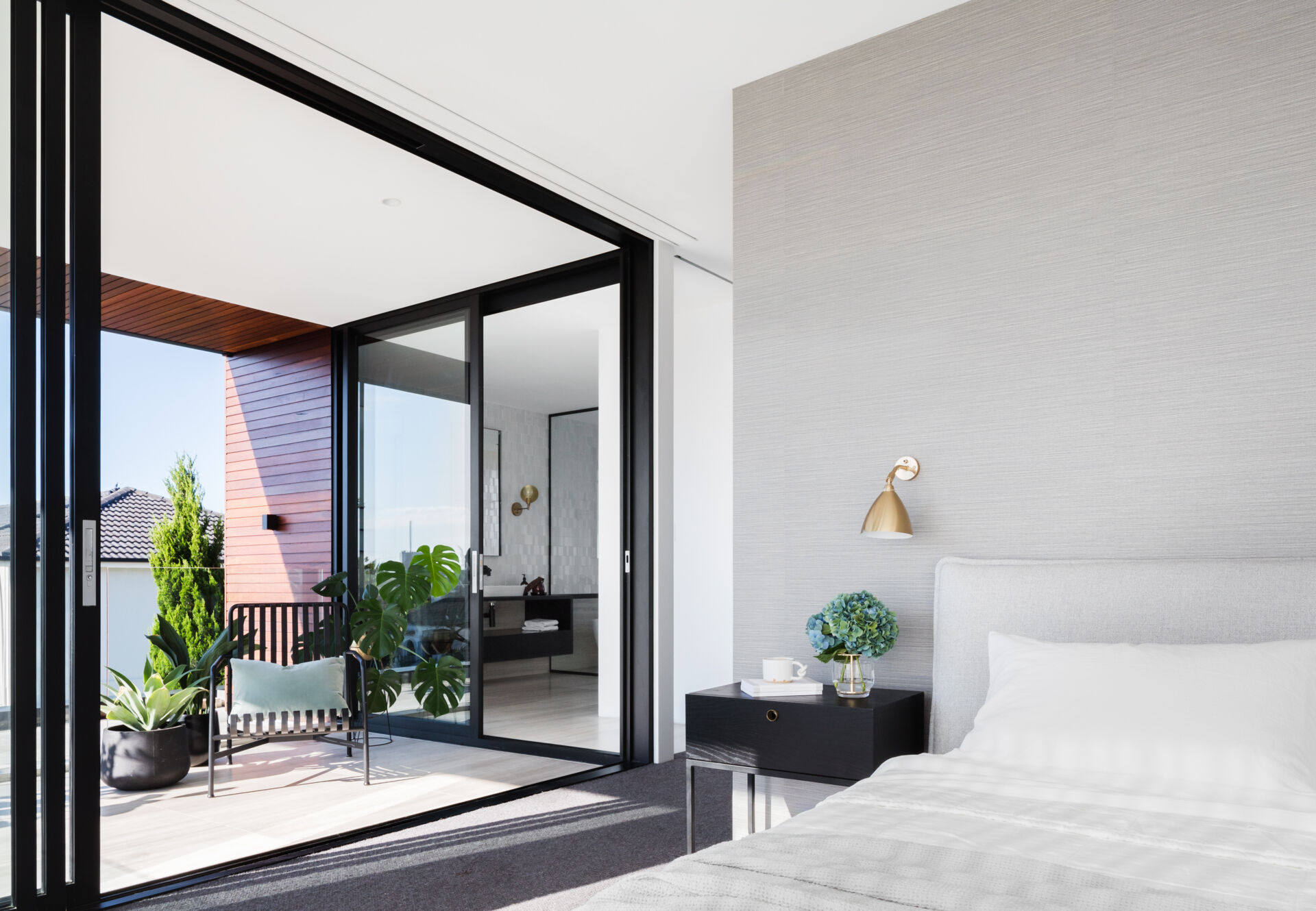 A master bedroom with sliding doors opening to a private balcony offers a peaceful retreat.