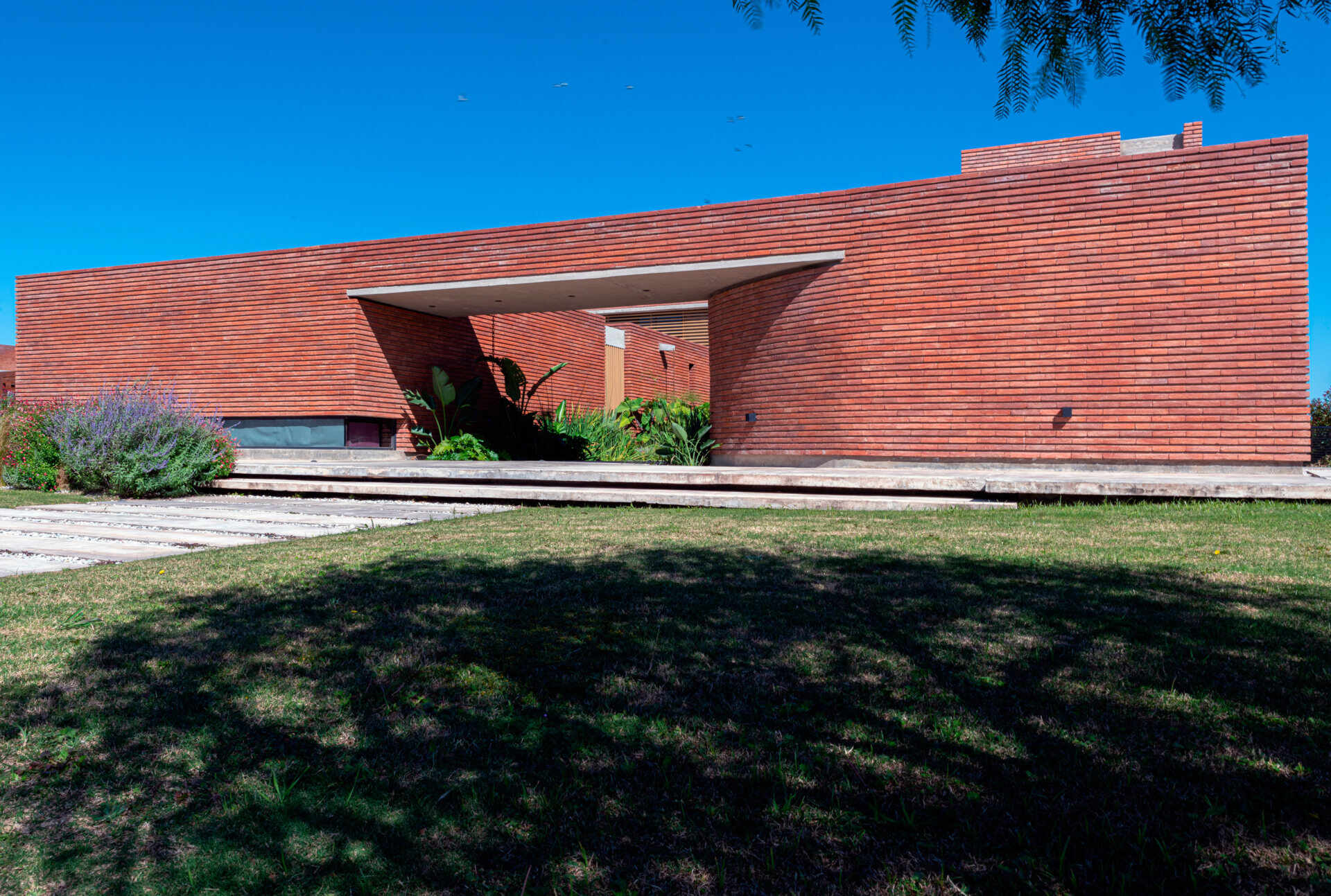 A brick family house in Córdoba designed around courtyards, light, and the experience of arrival, where everyday entry becomes a meaningful moment.