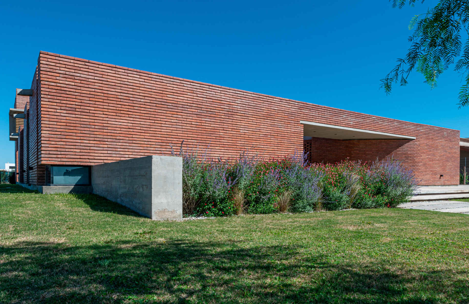 A brick family house in Córdoba designed around courtyards, light, and the experience of arrival, where everyday entry becomes a meaningful moment.