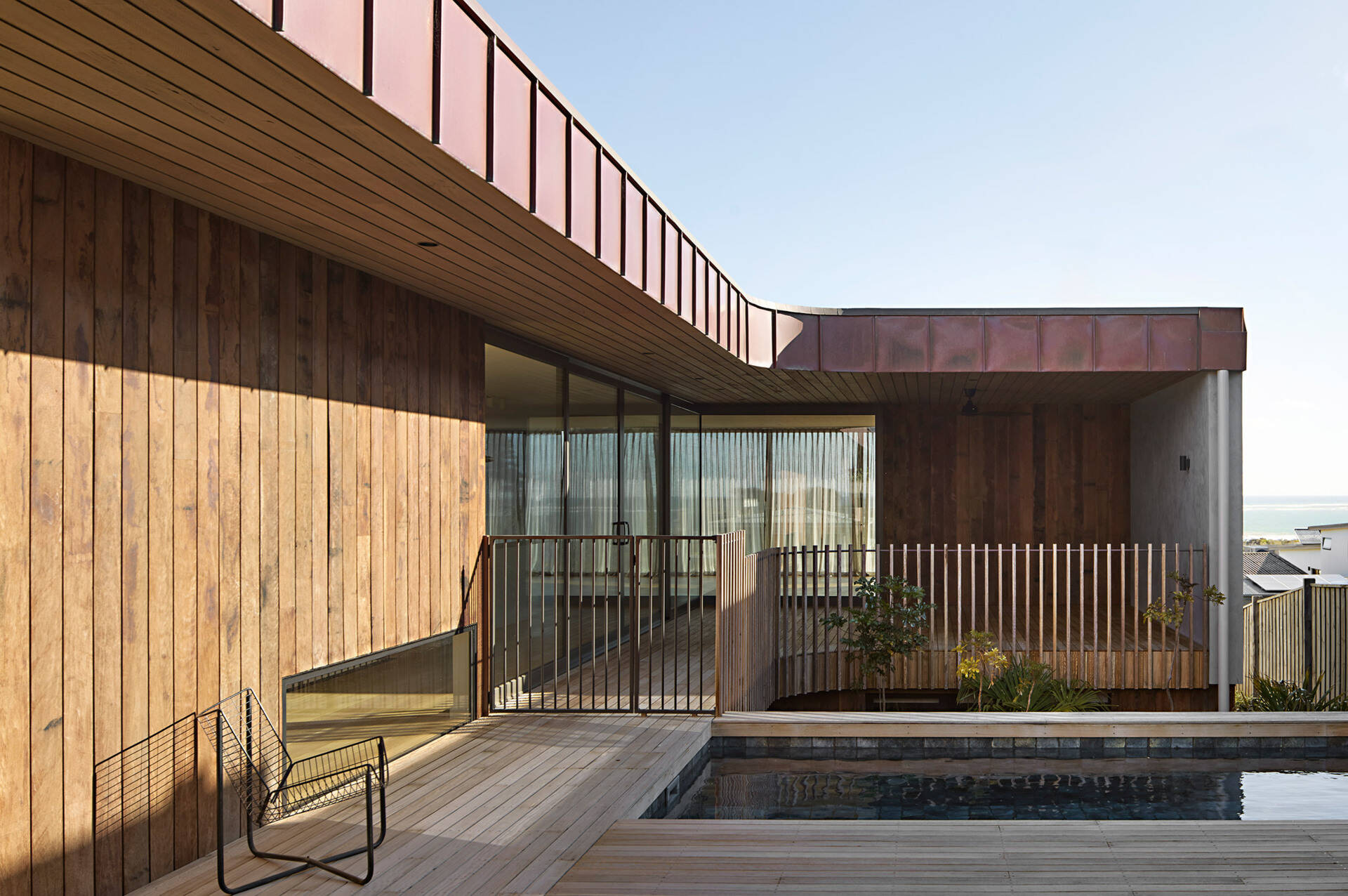 A sheltered pool and courtyard sit at the heart of this Ocean Grove home, where a semi courtyard layout draws in northern light while protecting outdoor spaces from coastal winds. Natural materials, planted gardens, and strong visual links to the interiors create a calm, private setting designed to be used year round.