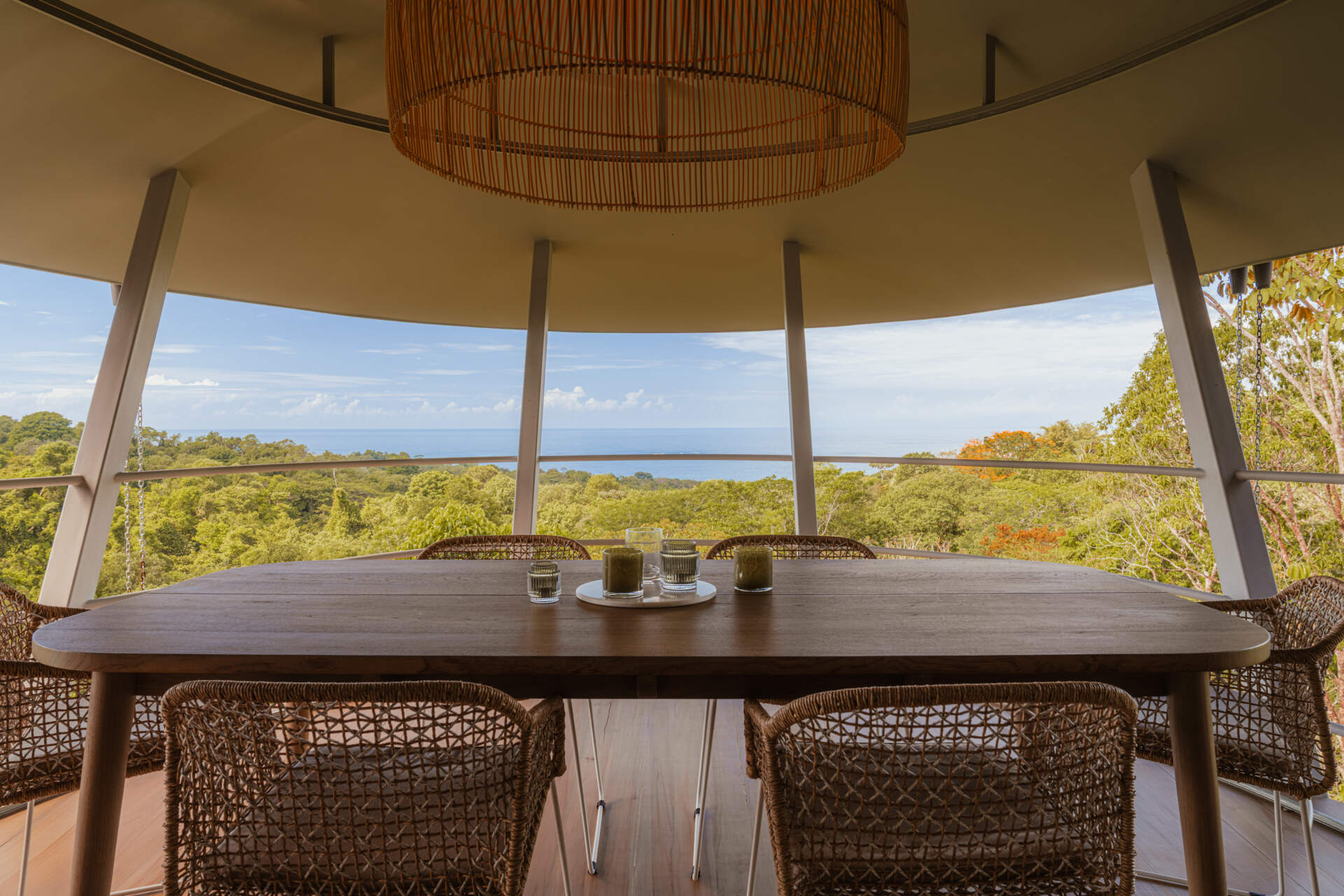 Stepping into the home, the dining area is fully open to the landscape, without windows or doors separating inside from outside. This openness supports a lifestyle centered on comfort through climate.
