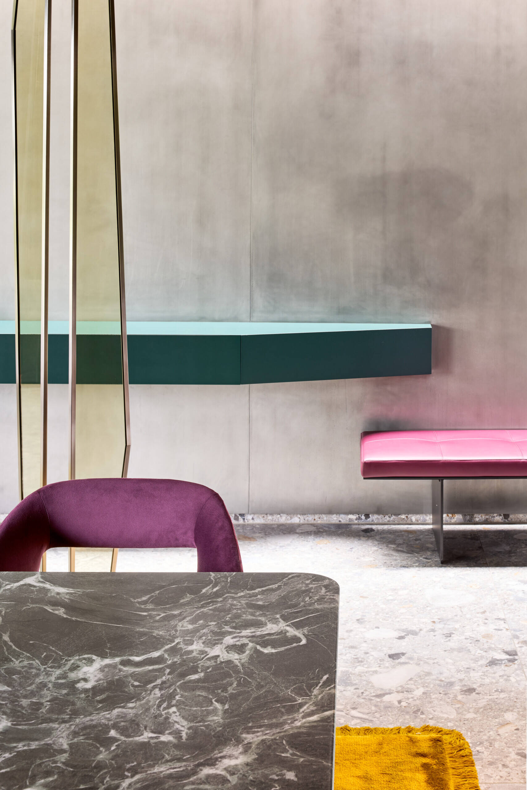 This dining space balances soft elegance with a little sparkle. A smoky-glass globe chandelier stretches above the stone table top, while plush plum velvet chairs add rich texture and comfort.