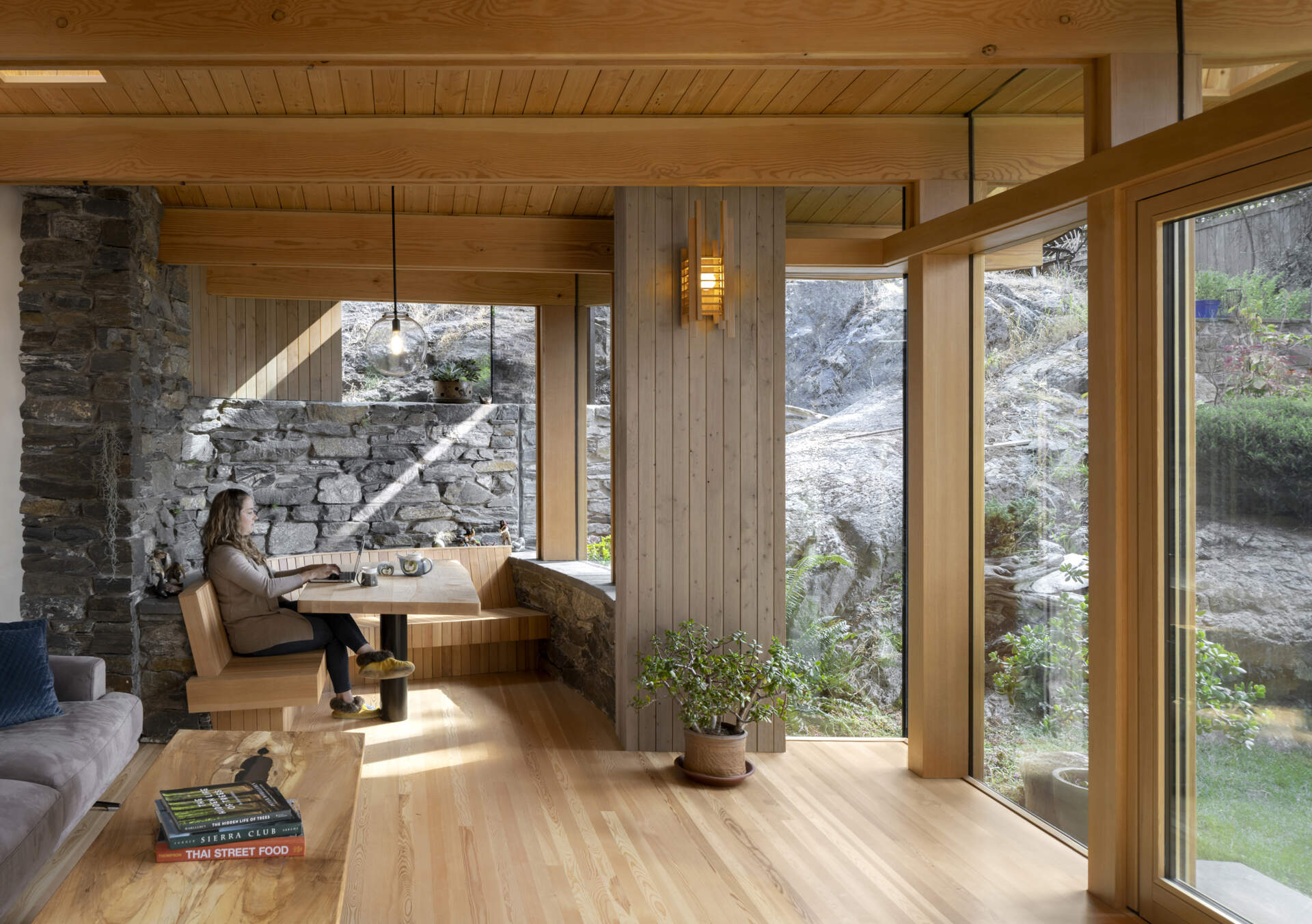 Built in seating and concealed storage allow the room to shift from work to family life, keeping the space calm, flexible, and uncluttered.