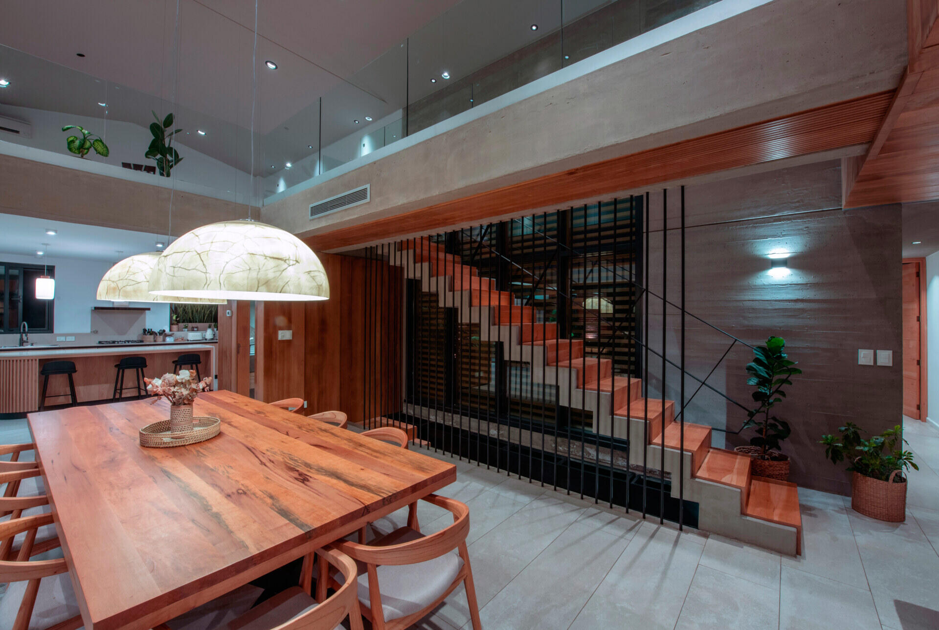 An open plan dining area that opens to a covered terrace with an outdoor kitchen and secondary dining area.