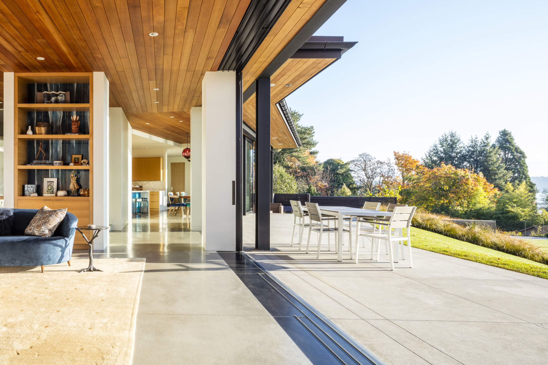 A sunny patio spans the full width of the house, designed to support seamless indoor and outdoor living.