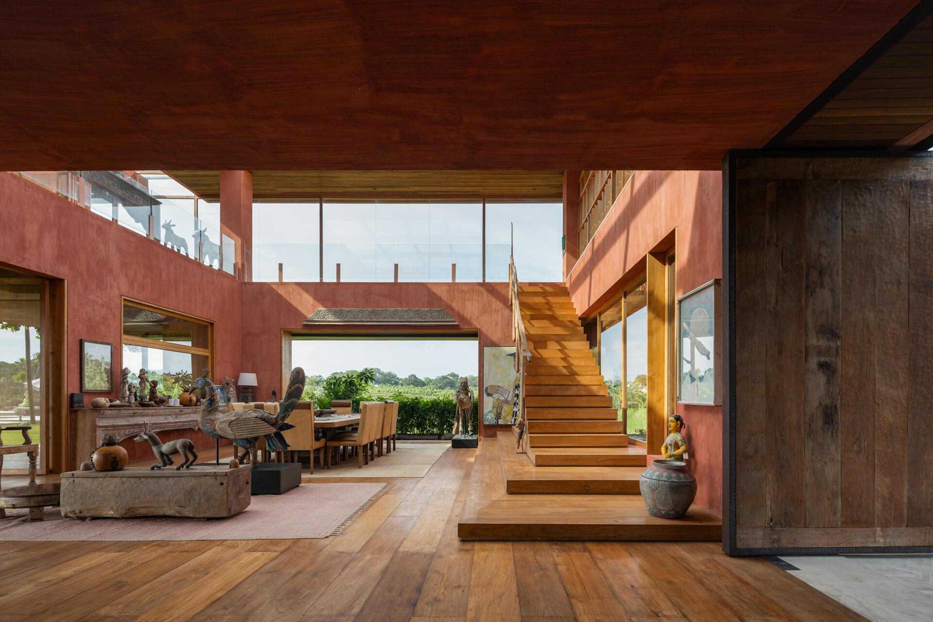 A wood staircase connects the levels in the top, from the social areas to the private spaces, like bedrooms and bathrooms.