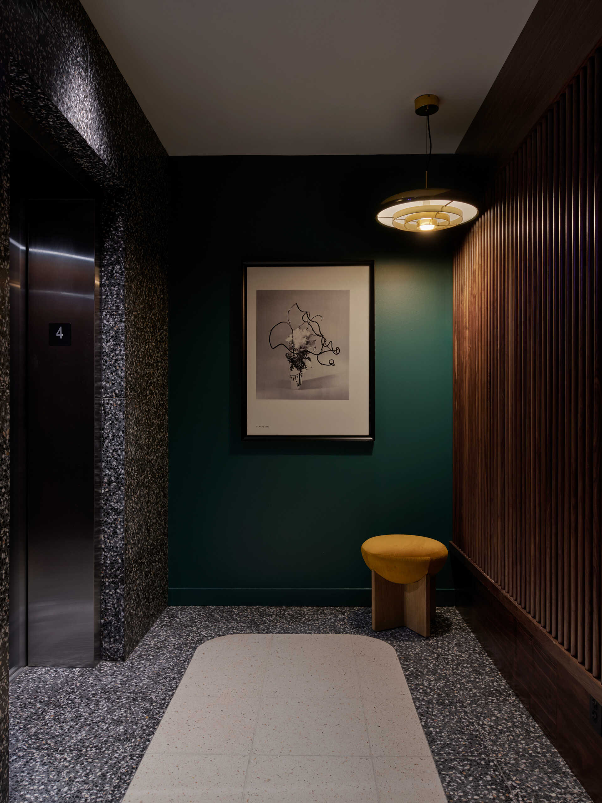 Custom carpets and preserved staircases guide guests from lively public spaces into quieter corridors throughout the hotel.