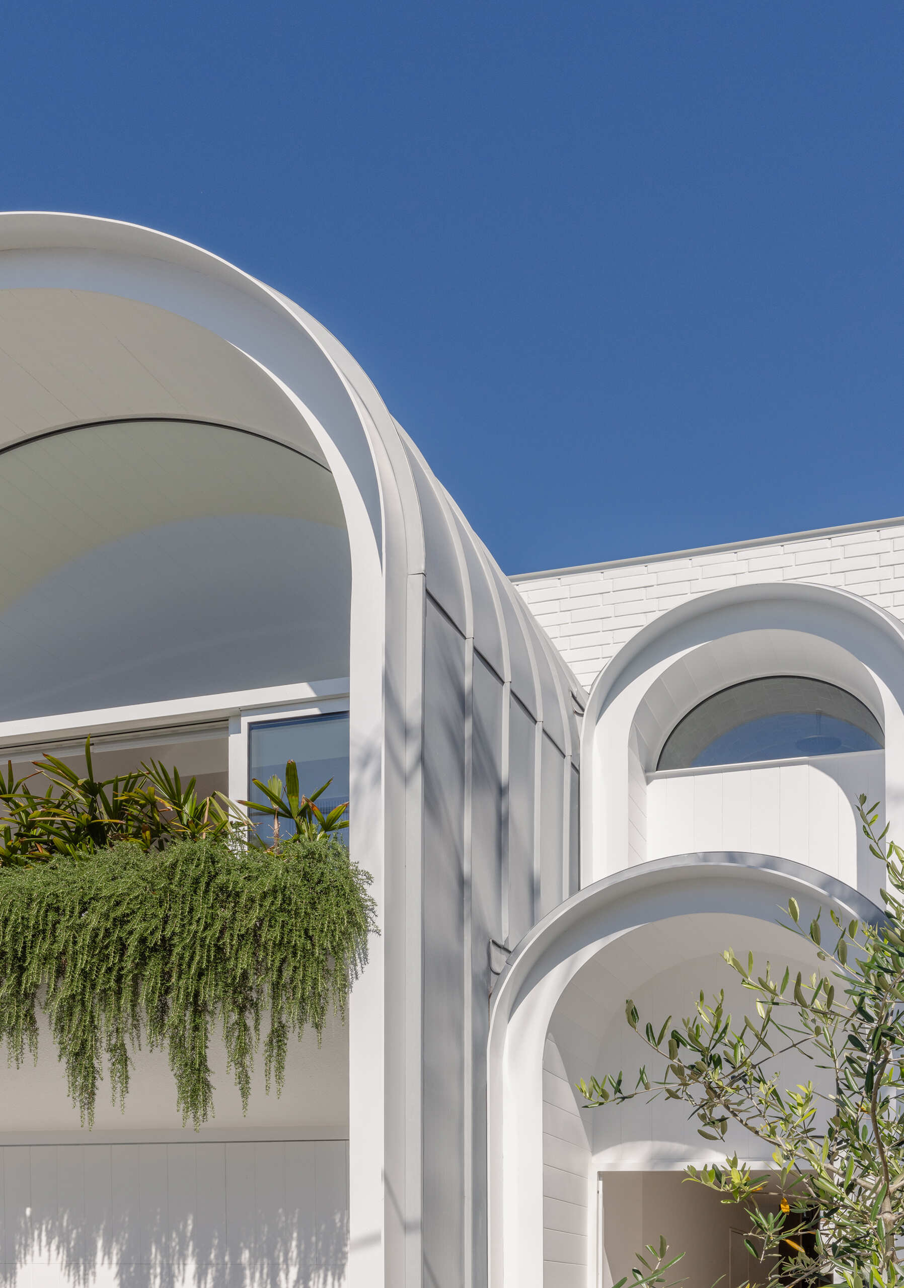 This Sydney home reimagines Federation forms using playful curves, brick volumes and carefully controlled light.