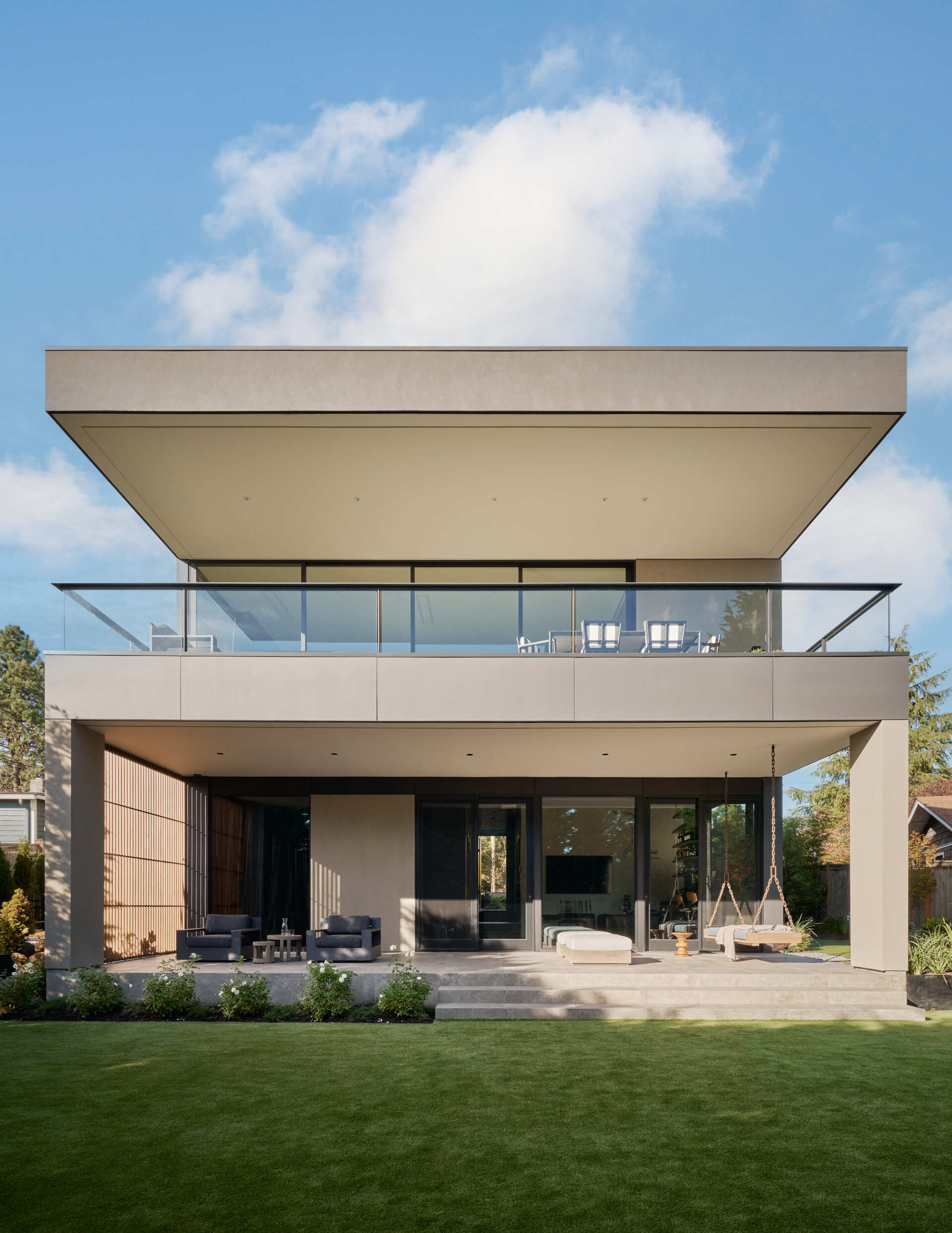 The lake-view terrace connects indoors and outdoors seamlessly, while layered screens soften views and keep the space airy.