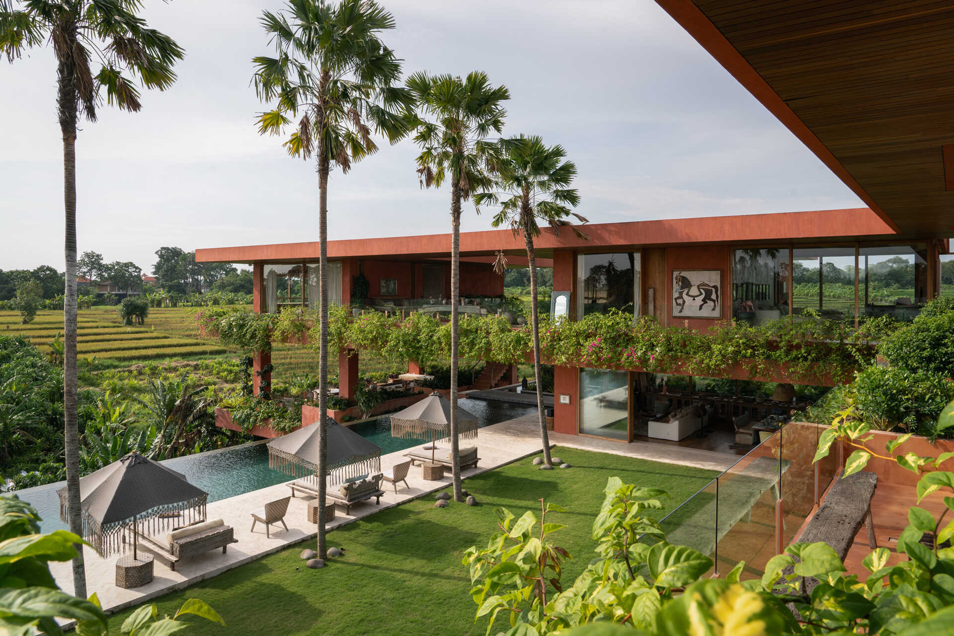 Terracotta-toned concrete, raw geometry, and warm wood define this brutalist house designed to frame art rather than compete with it.