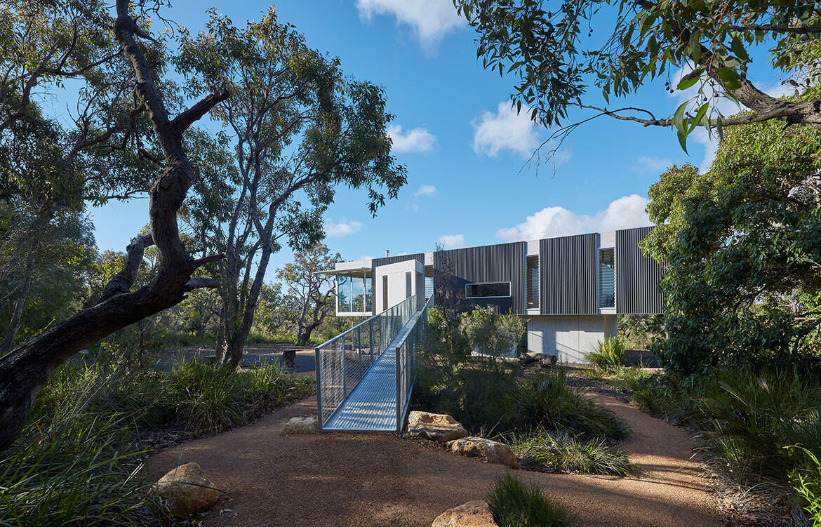 This elevated Australian home is clad in durable, bushfire-resistant finishes of Colorbond, steel, cement and spotted gum.