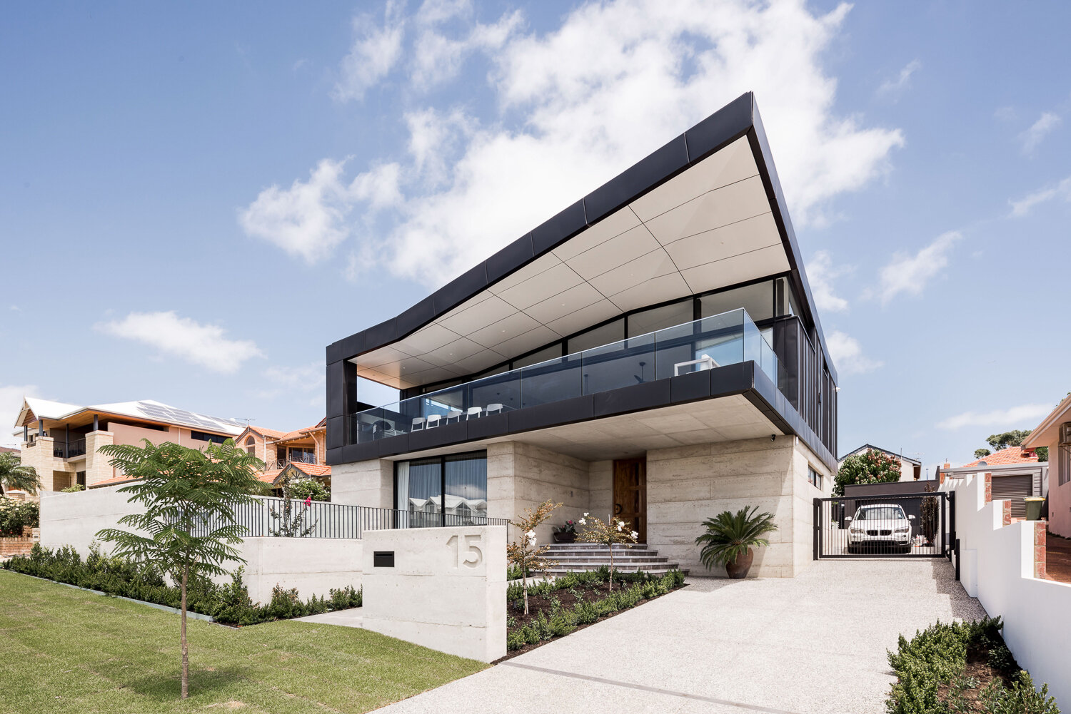 A modern East Fremantle home featuring a folded skillion roof and angular design, carefully shaped to capture sweeping river and city views.