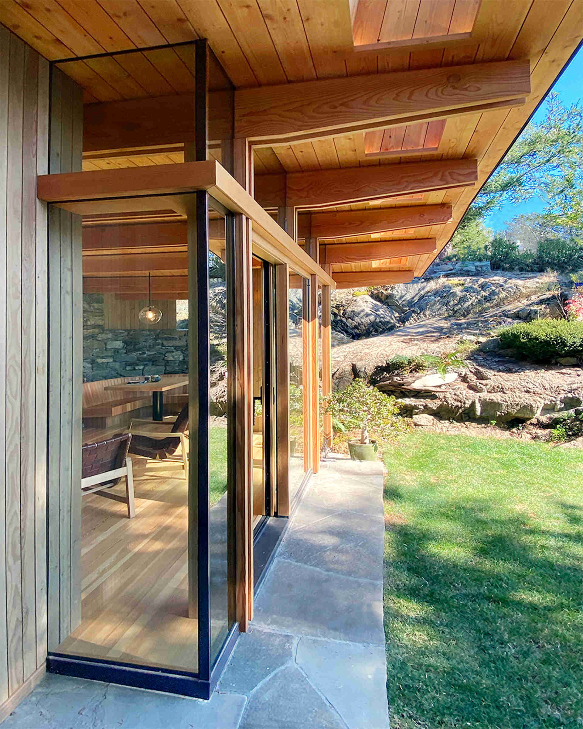Island sourced timbers, stone from the site, and passive solar overhangs create a structure rooted in place and tuned for year round comfort.
