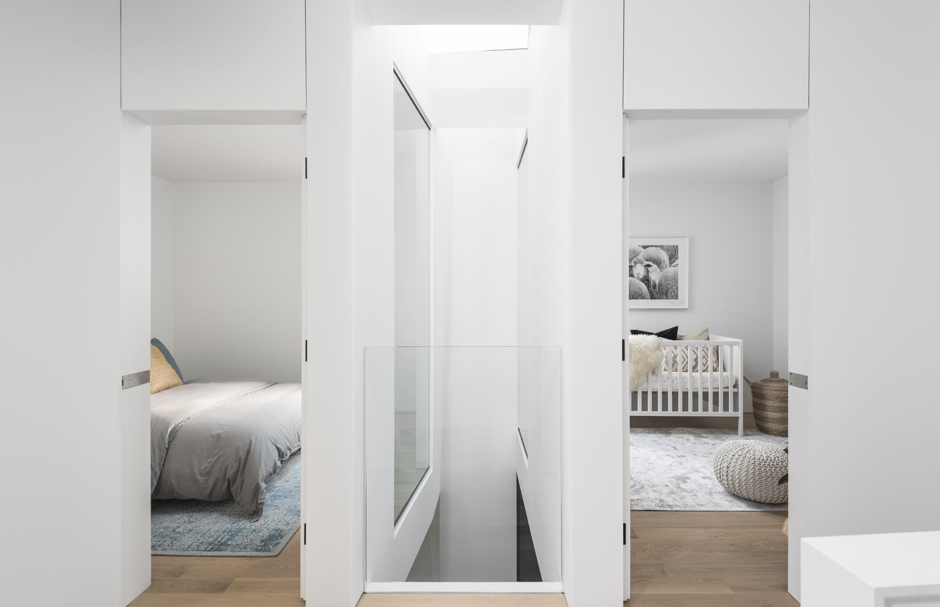 Architectural voids at the top of the stairs allow natural light to flow through multiple levels of the home.