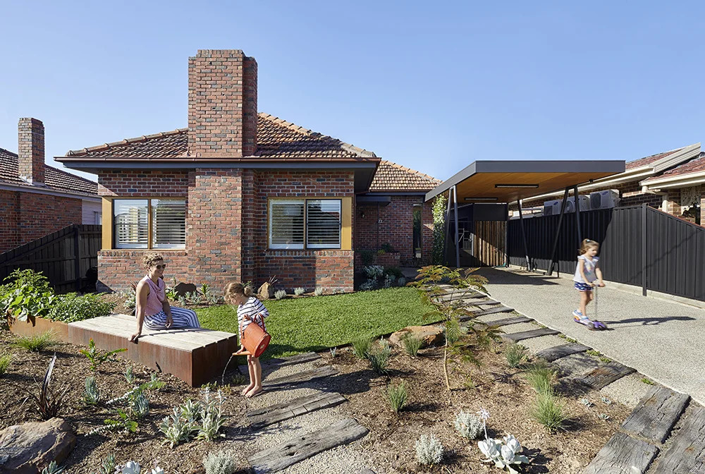 A 1960s Melbourne brick home reimagined with a new carport and garden-facing extension that completely changes how the house is used.