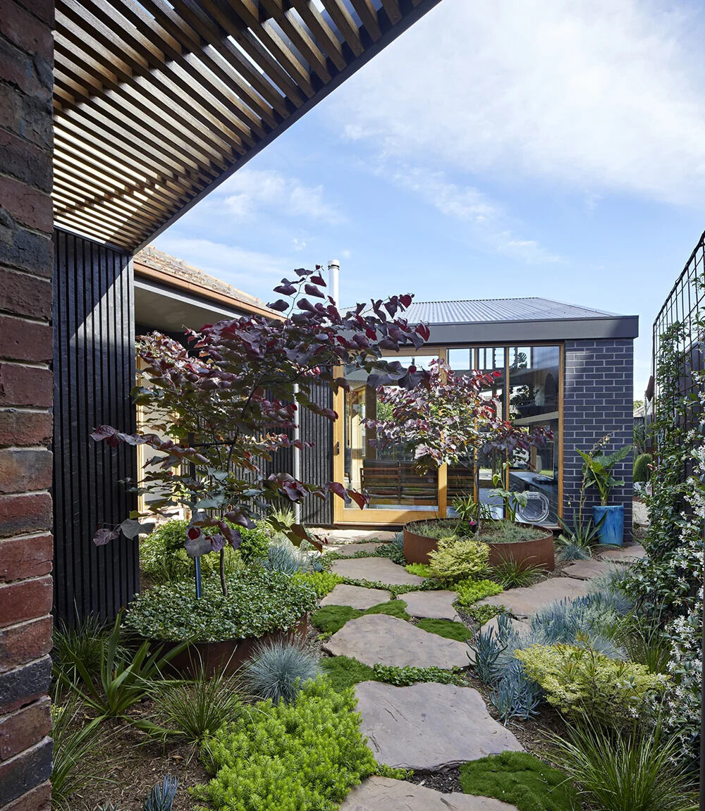 A 1960s Melbourne brick home reimagined with a new carport and garden-facing extension that completely changes how the house is used.