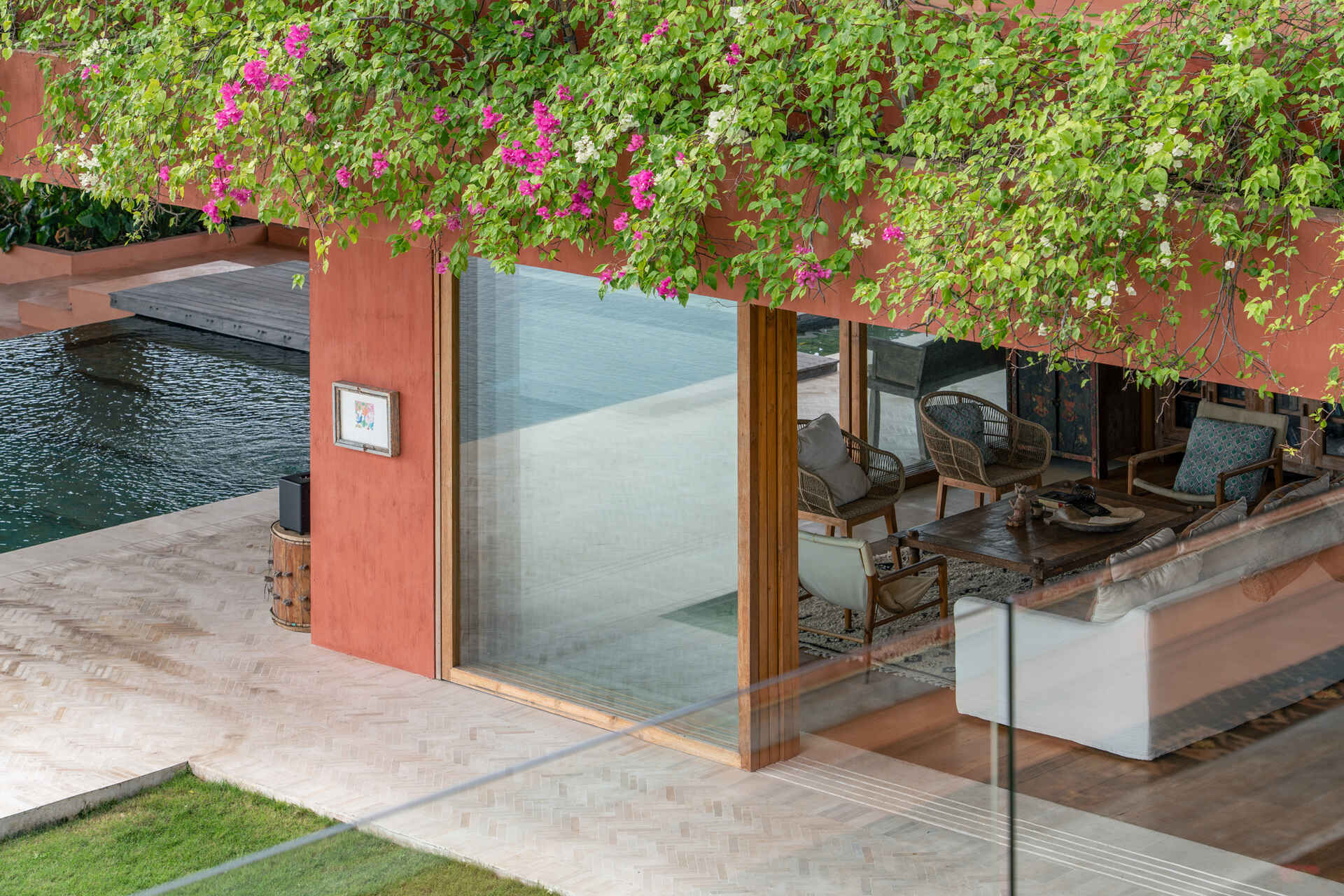 Terracotta-toned concrete, raw geometry, and warm wood define this brutalist house designed to frame art rather than compete with it.