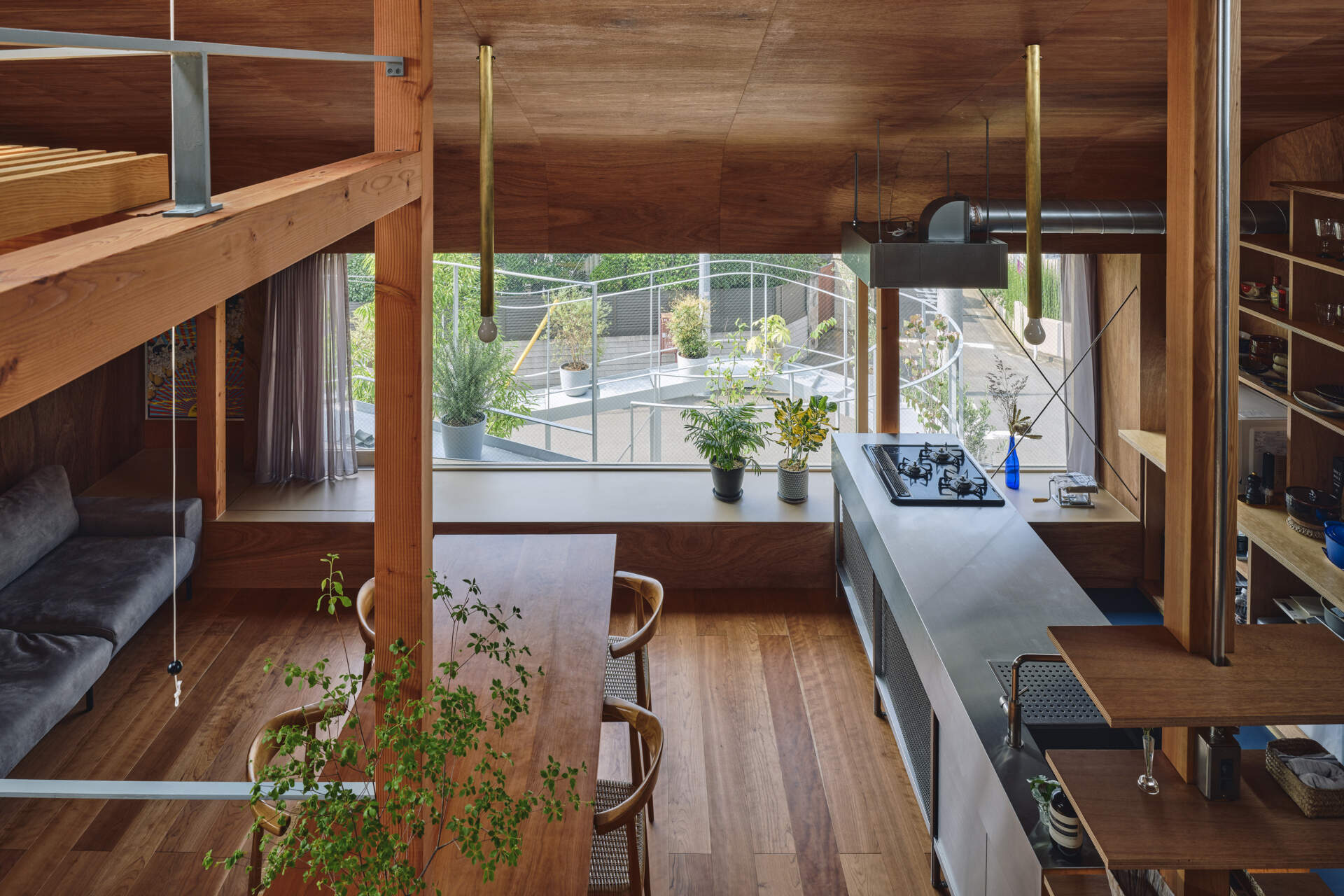 This home office is woven into the daily flow of the house, where split levels, displayed objects, and garden views shape a calm, thoughtful place to work within a dense Tokyo neighborhood.
