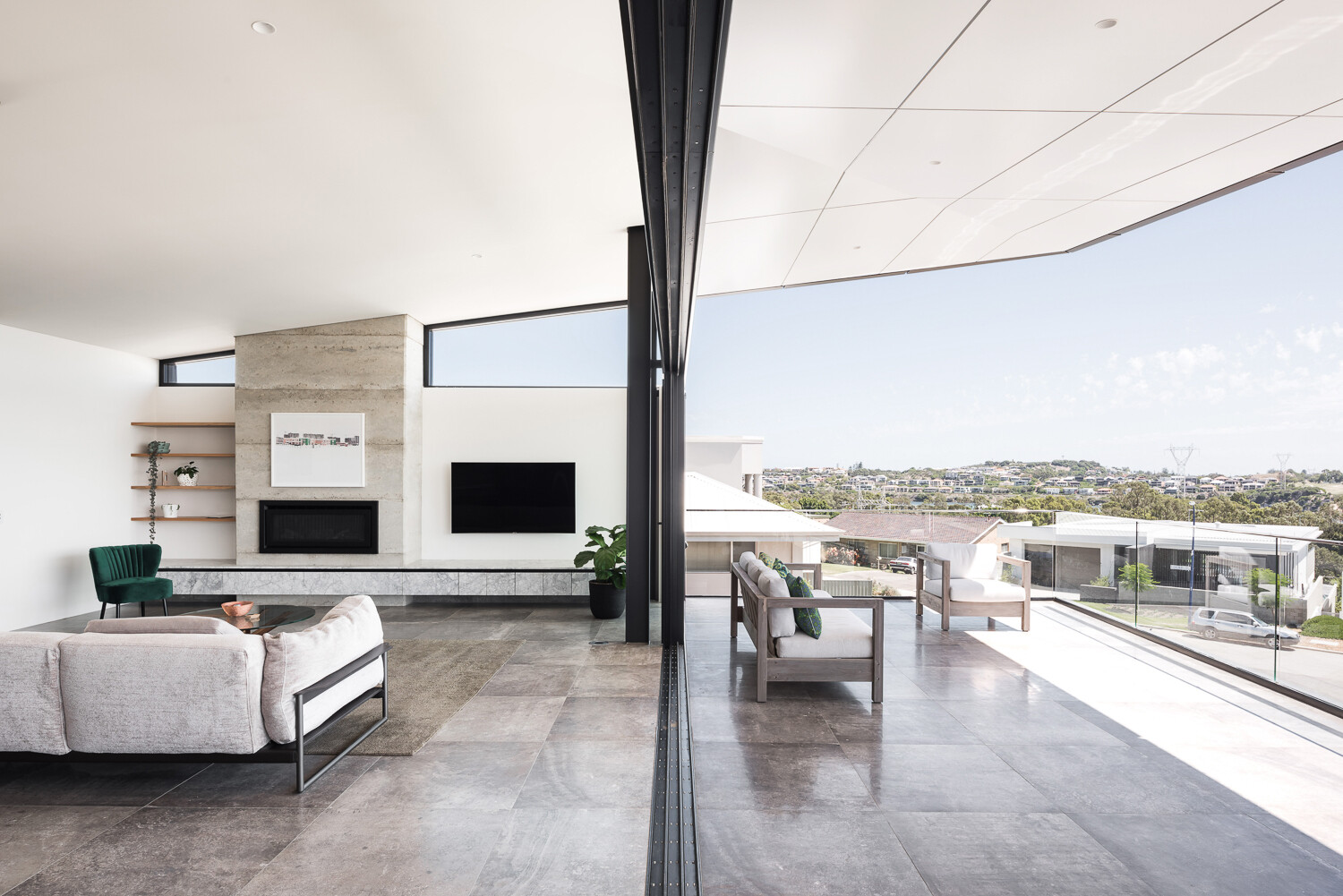 An balcony with space for lounging, dining and an outdoor kitchen becomes a true extension of the living area.