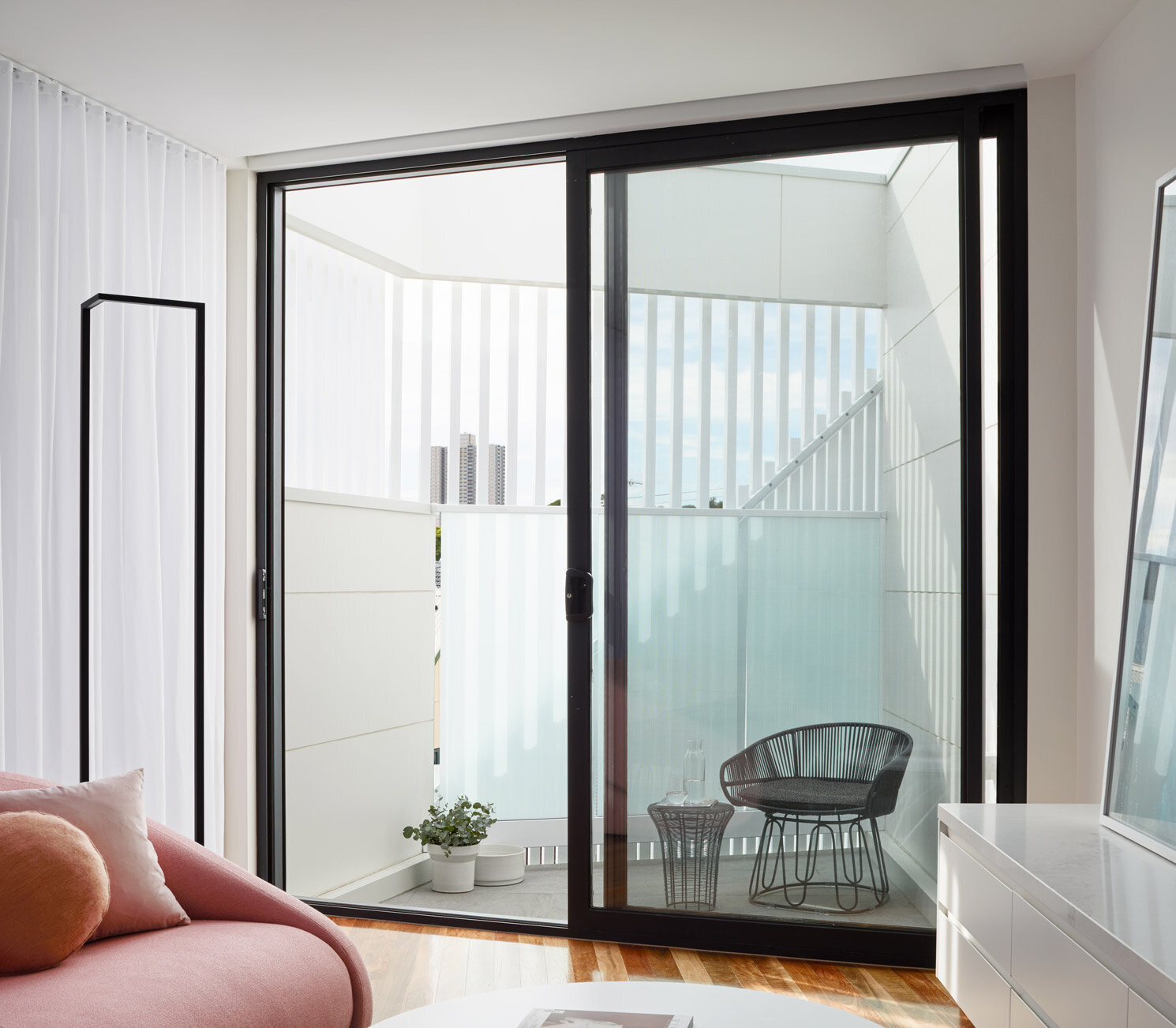 A small upper-level balcony extends the living area outdoors and offers elevated views toward the city.