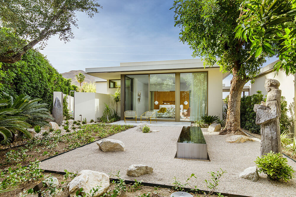 A private patio with sculpture and water feature designed as a calming retreat.