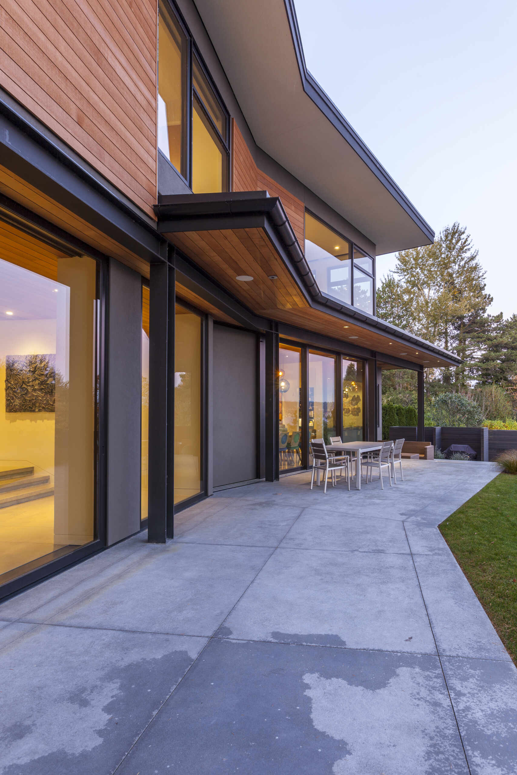 A sunny patio spans the full width of the house, designed to support seamless indoor and outdoor living.