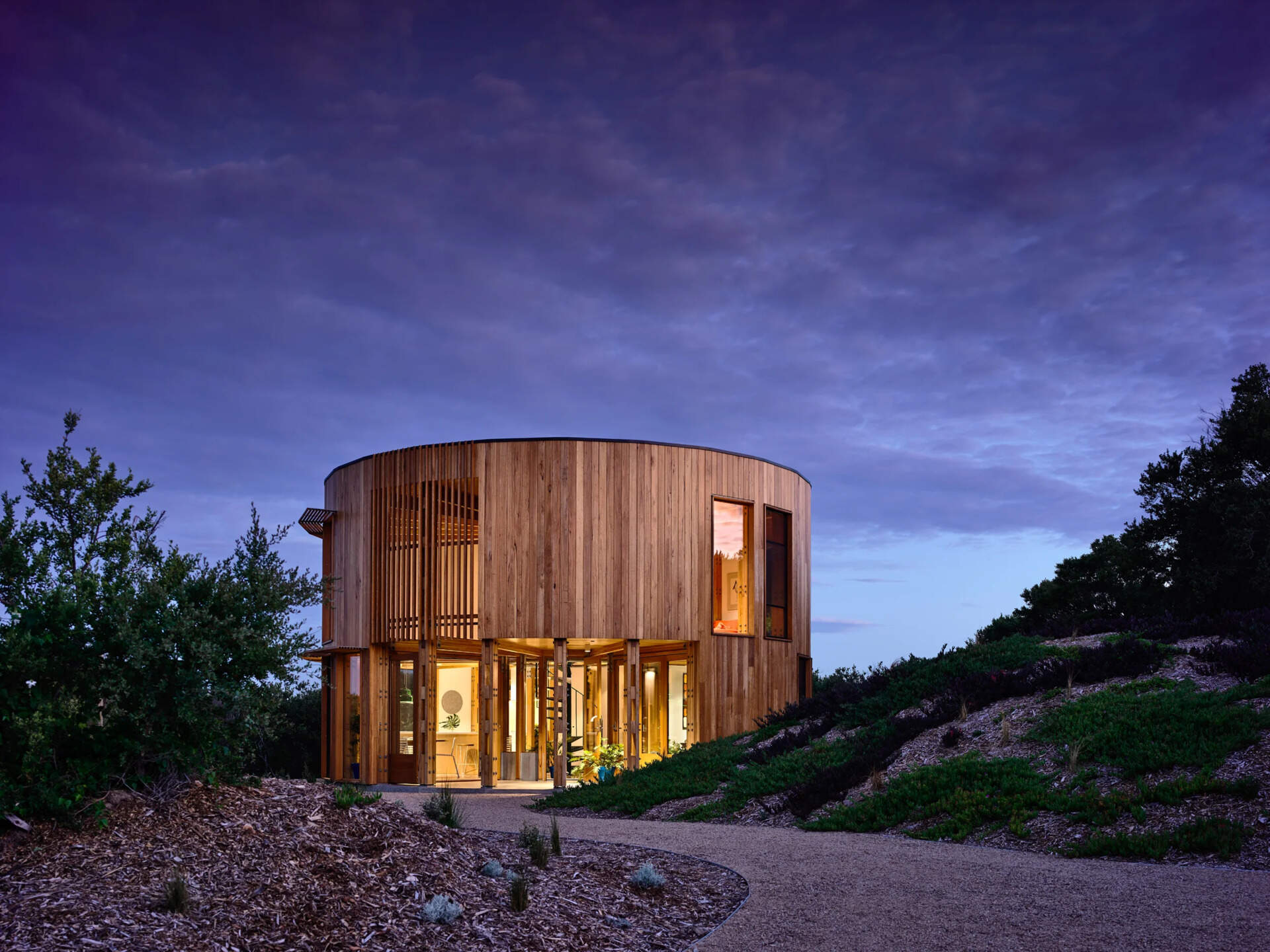 A compact circular beach house on the Mornington Peninsula designed for slow living and simplicity by the sea.