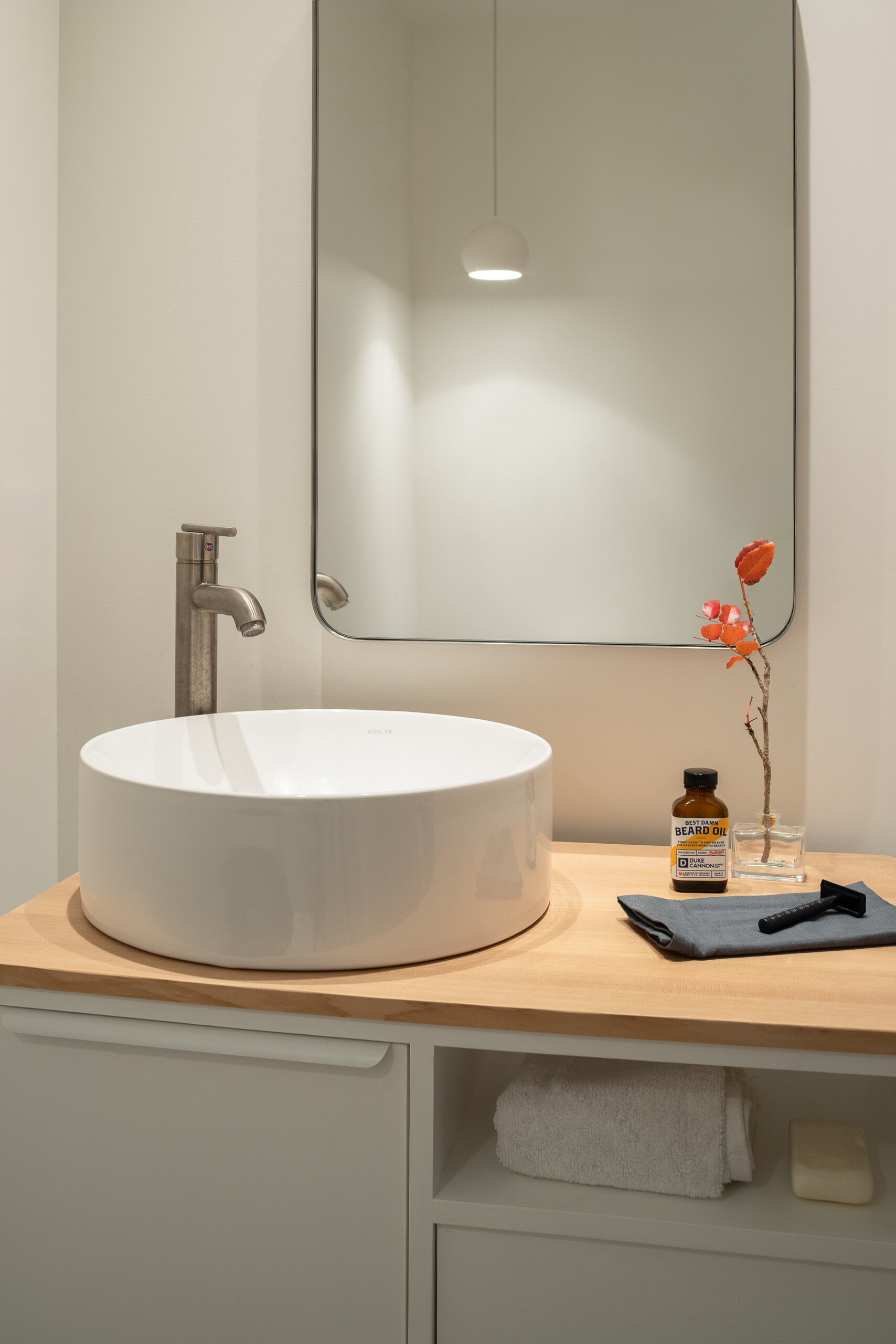 Bathroom casework was hand-built by the owner using hemlock and painted plywood, continuing the theme of personal involvement and material honesty throughout the interior.