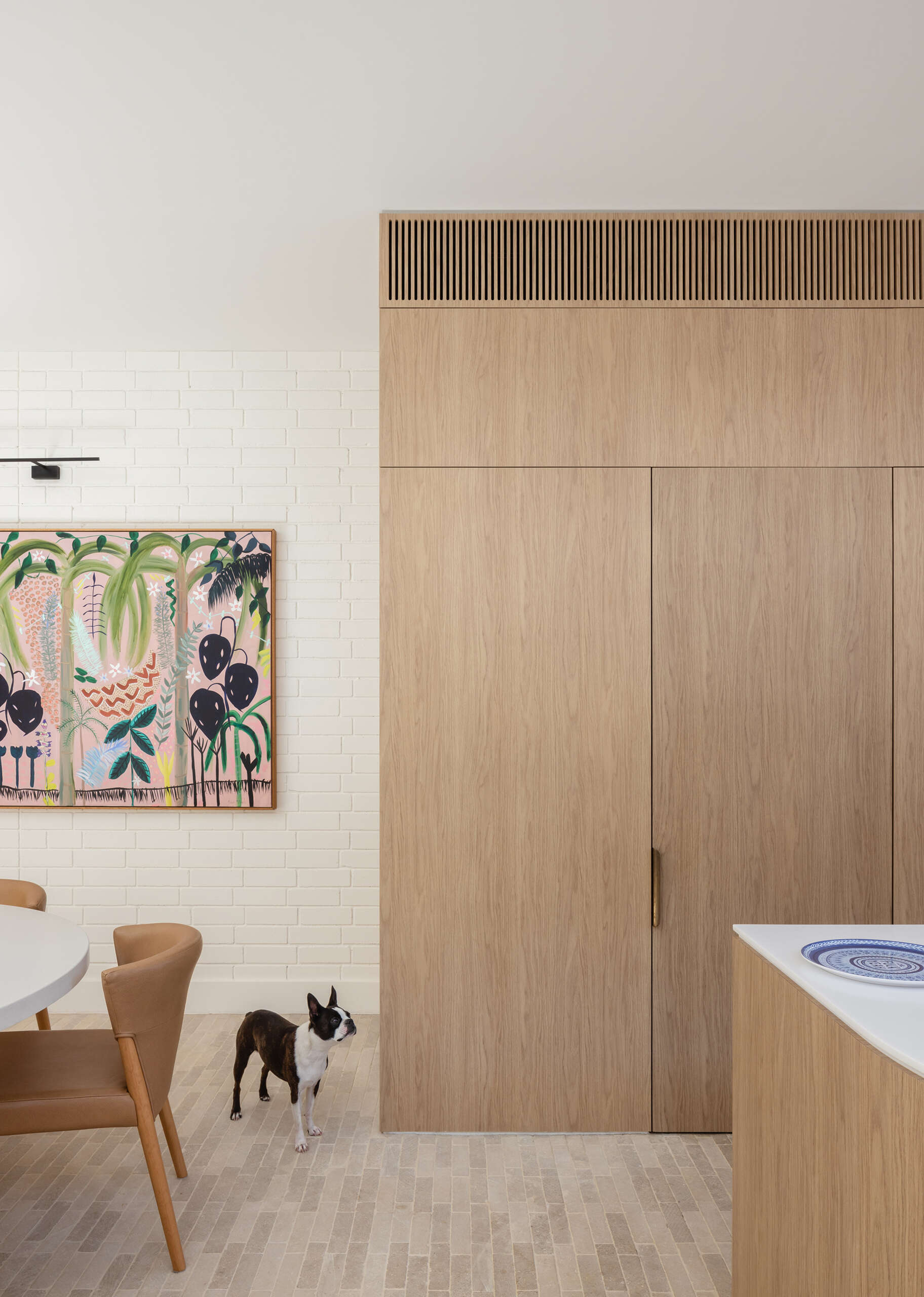 The kitchen sits within the open ground floor plan, defined by integrated joinery. It forms part of a shared zone with the dining and living spaces.