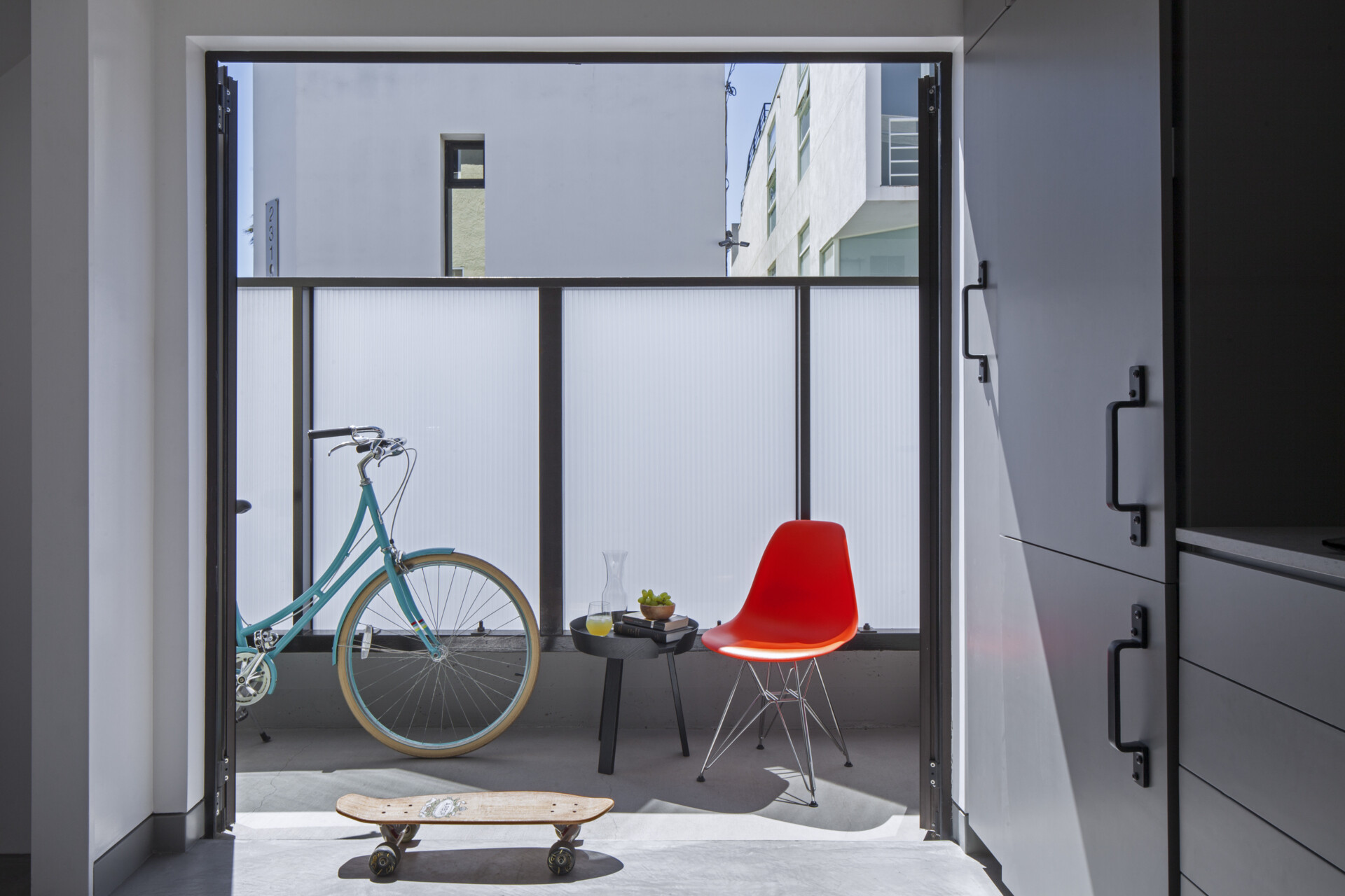 Double doors open to a patio, bringing natural light deep into this 320 sq ft Venice apartment and visually expanding the interior.