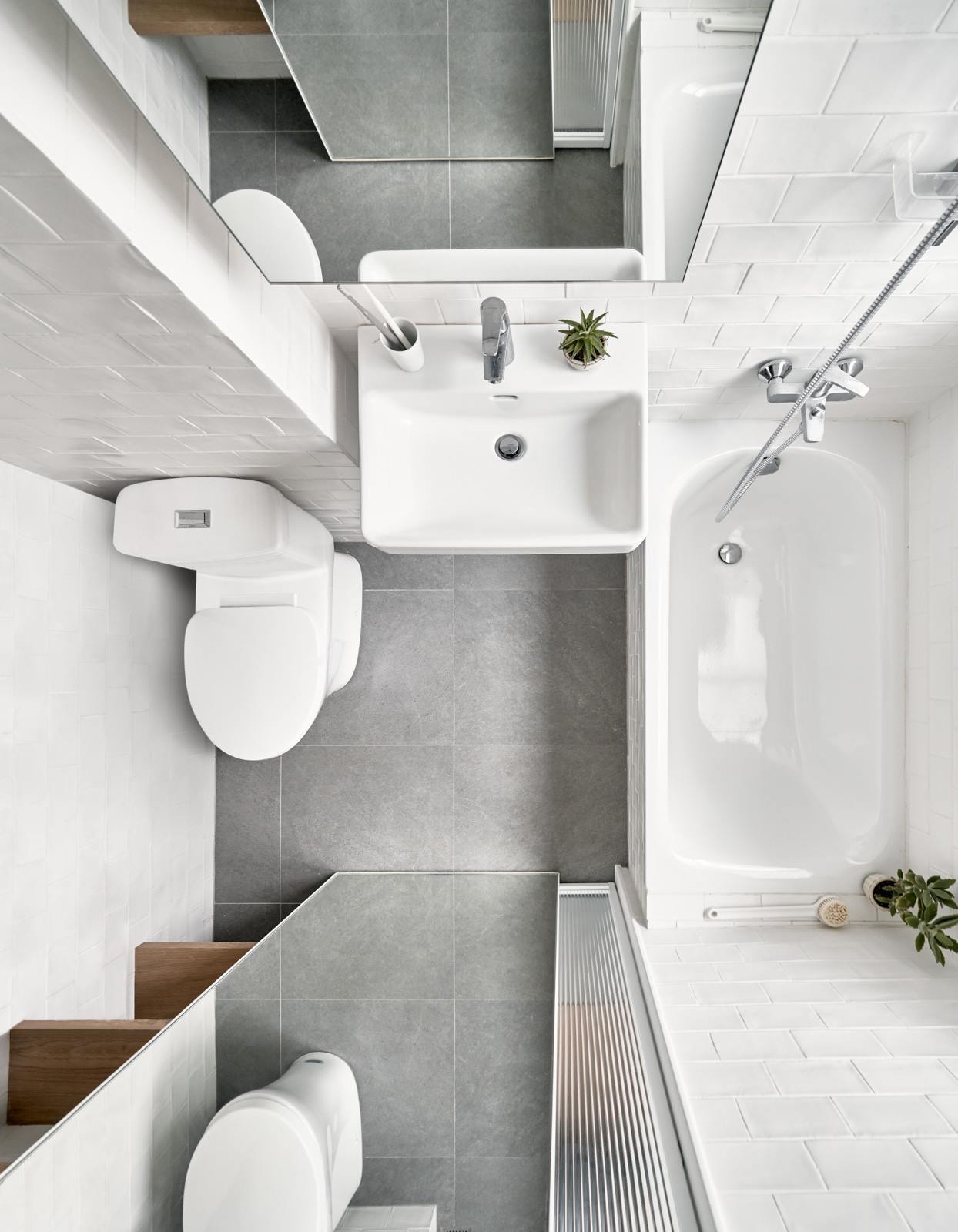 White walls and smart layout choices make this small Taipei bathroom feel bright and functional, complete with open shelving and a bath shower combo.