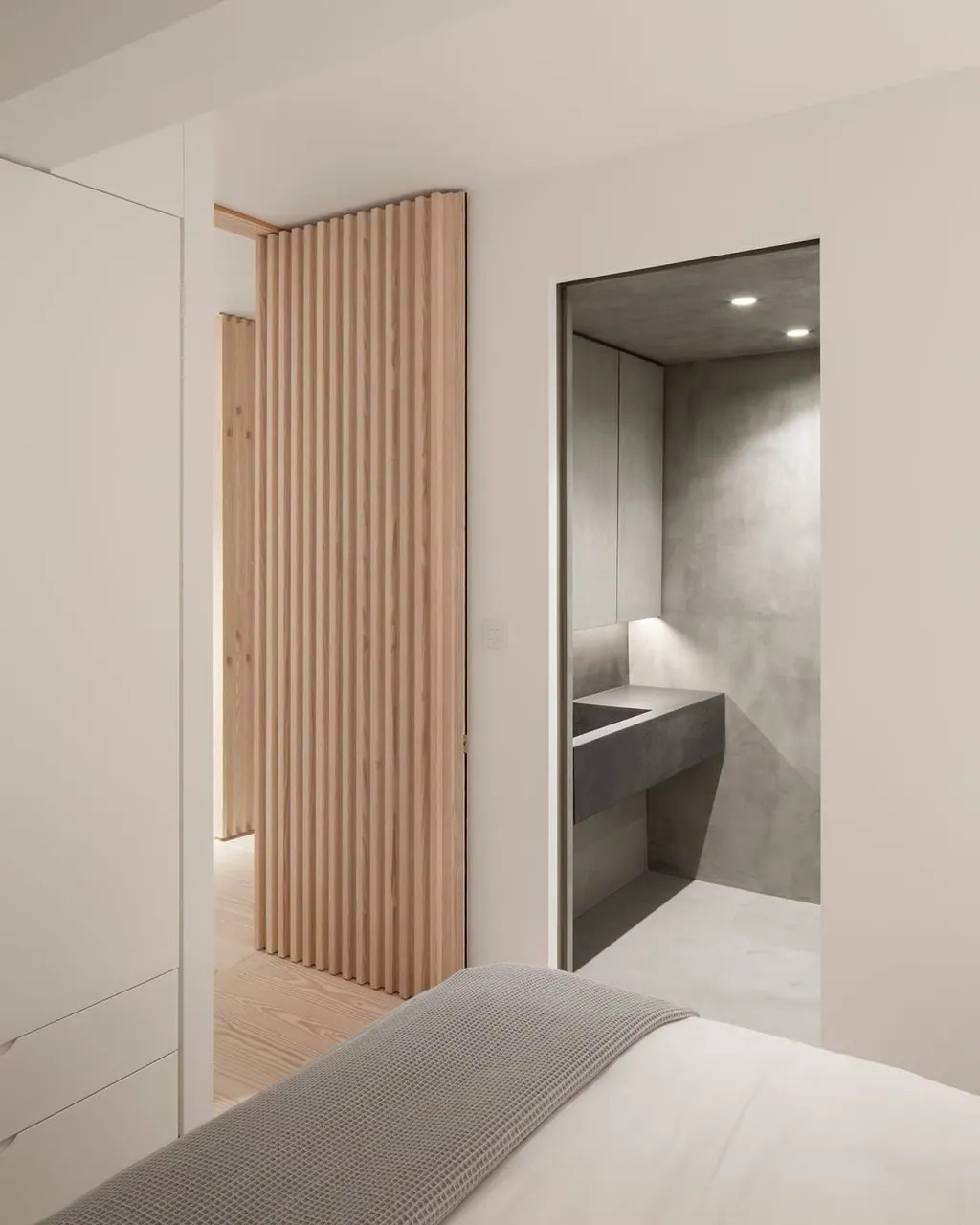 Simply finished bedrooms with built-in cupboards, bespoke Douglas fir bedside cabinetry, and hidden lighting for a calm, restful atmosphere.