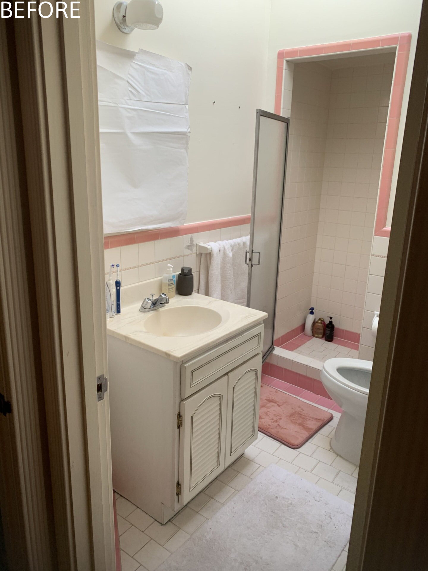 Before renovation, the guest bathroom shared the same limitations of low light and constrained proportions. In response, the design takes an opposite tonal approach to the main bath. Varied sizes of white stack bond tiles create graphic interest while visually enlarging the modest room. The brighter palette amplifies available light, making the space feel more expansive.
