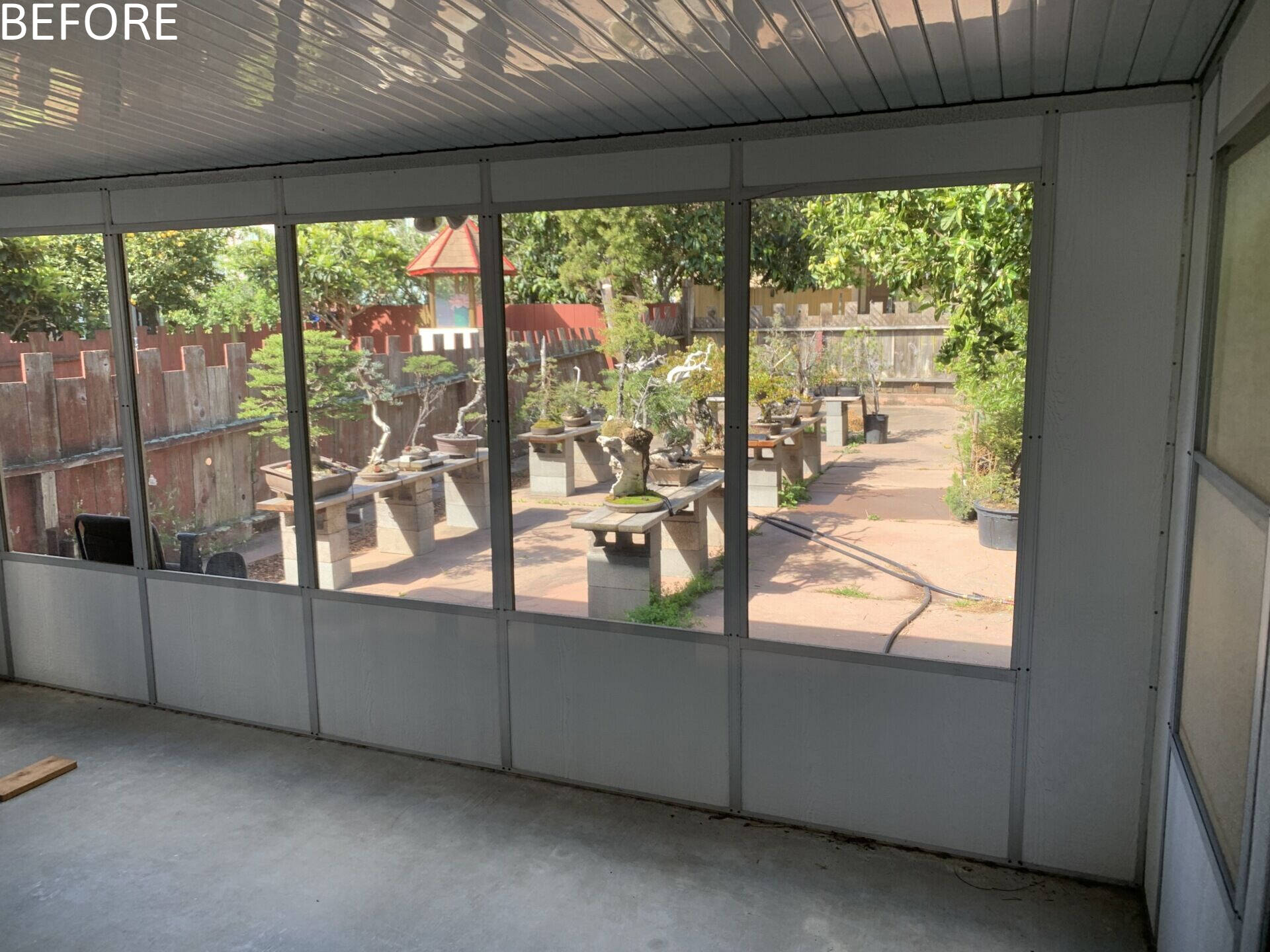 The renovation introduces a dedicated workshop environment with wide French doors opening from street to garden. Large carts can move bonsai trees directly from truck to backyard with ease, while still accommodating a single car garage.