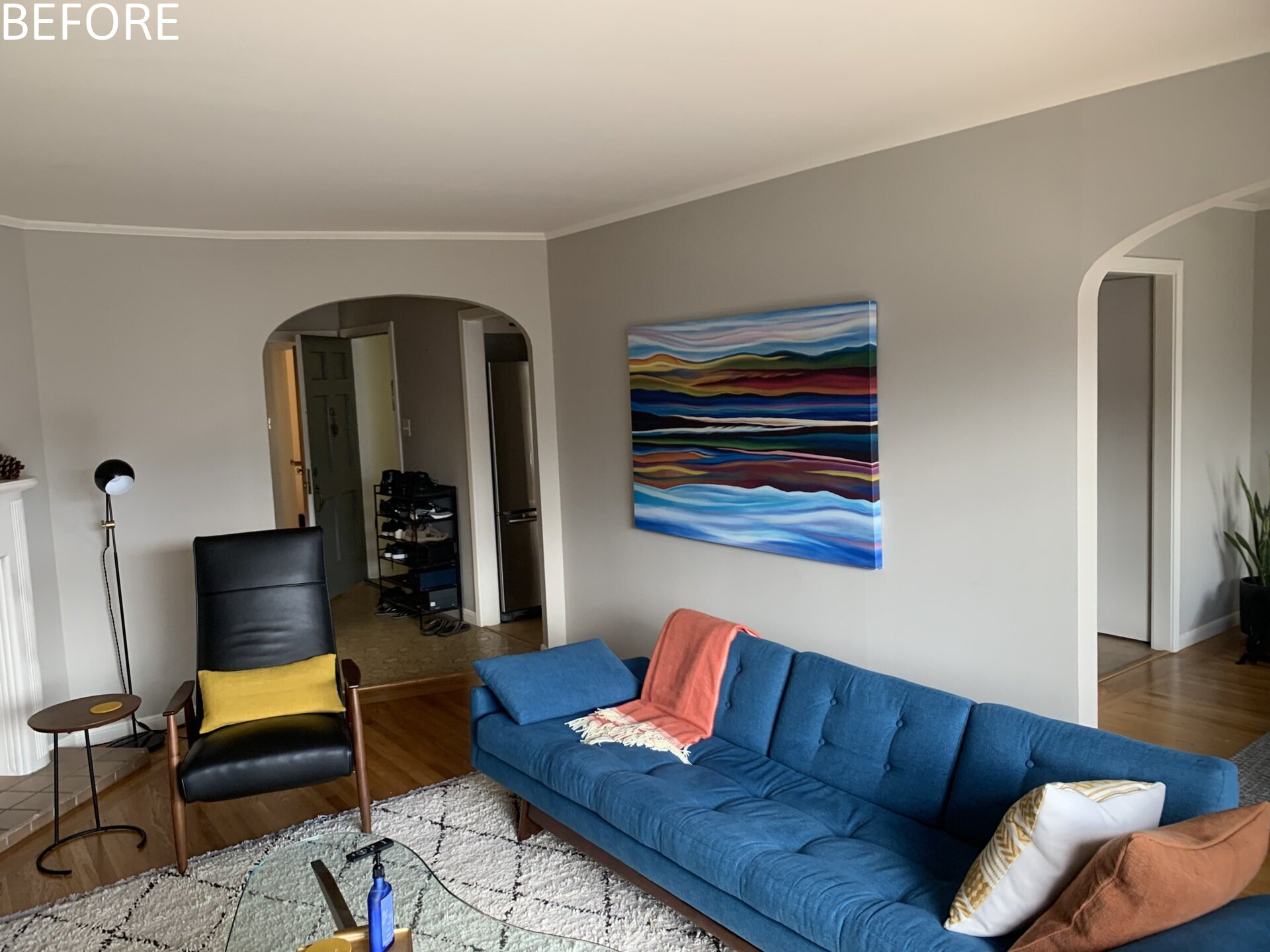 Previously, living spaces were segmented, cutting off visual connections and natural light. The layout felt constrained by its compartmentalized plan. Now, the living and dining areas unfold within the open upper level. Refinished original oak floors in a deeper tone ground the space, complemented by walnut millwork that adds warmth without overwhelming the volume.