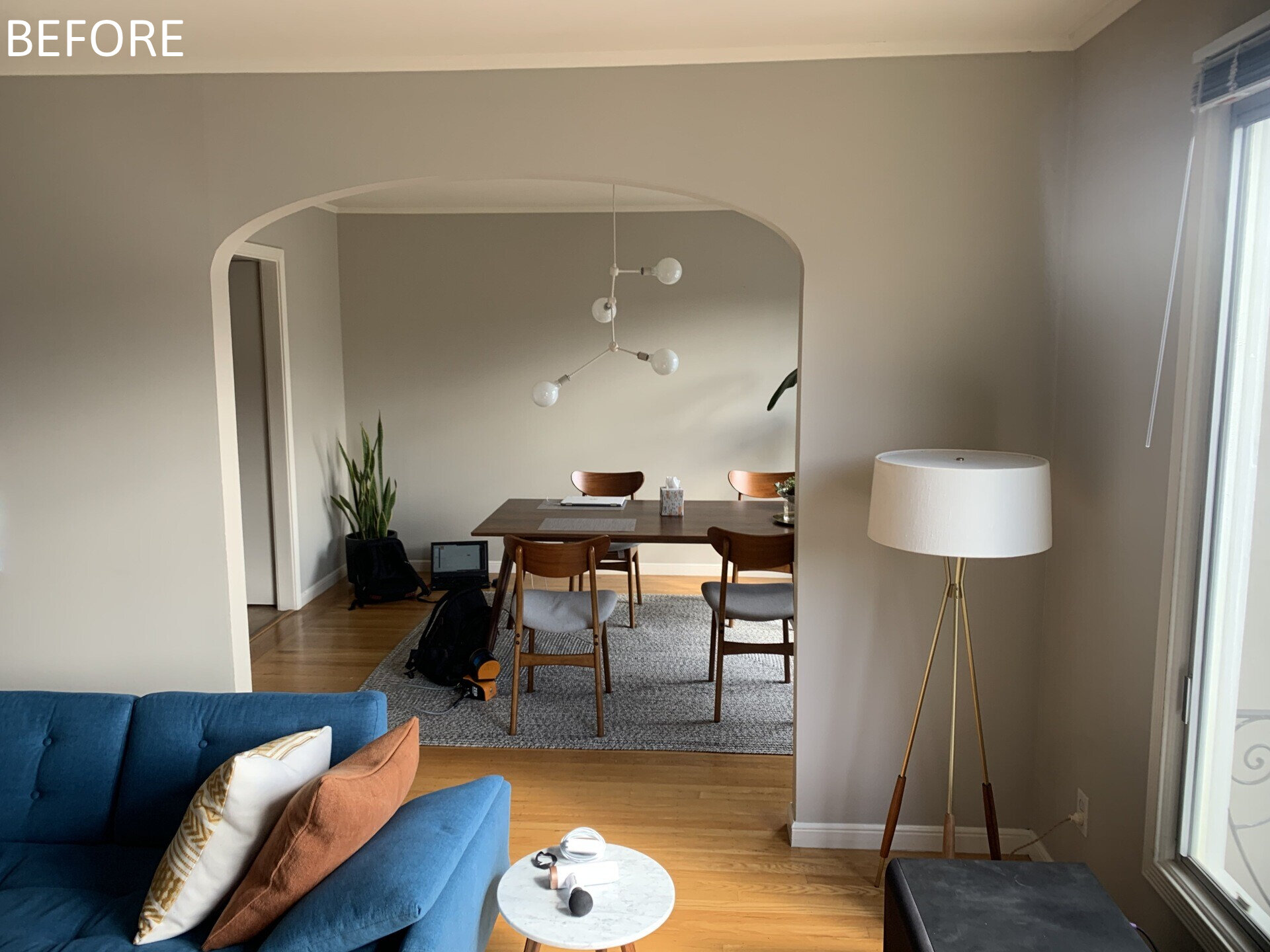 Previously, living spaces were segmented, cutting off visual connections and natural light. The layout felt constrained by its compartmentalized plan. Now, the living and dining areas unfold within the open upper level. Refinished original oak floors in a deeper tone ground the space, complemented by walnut millwork that adds warmth without overwhelming the volume.