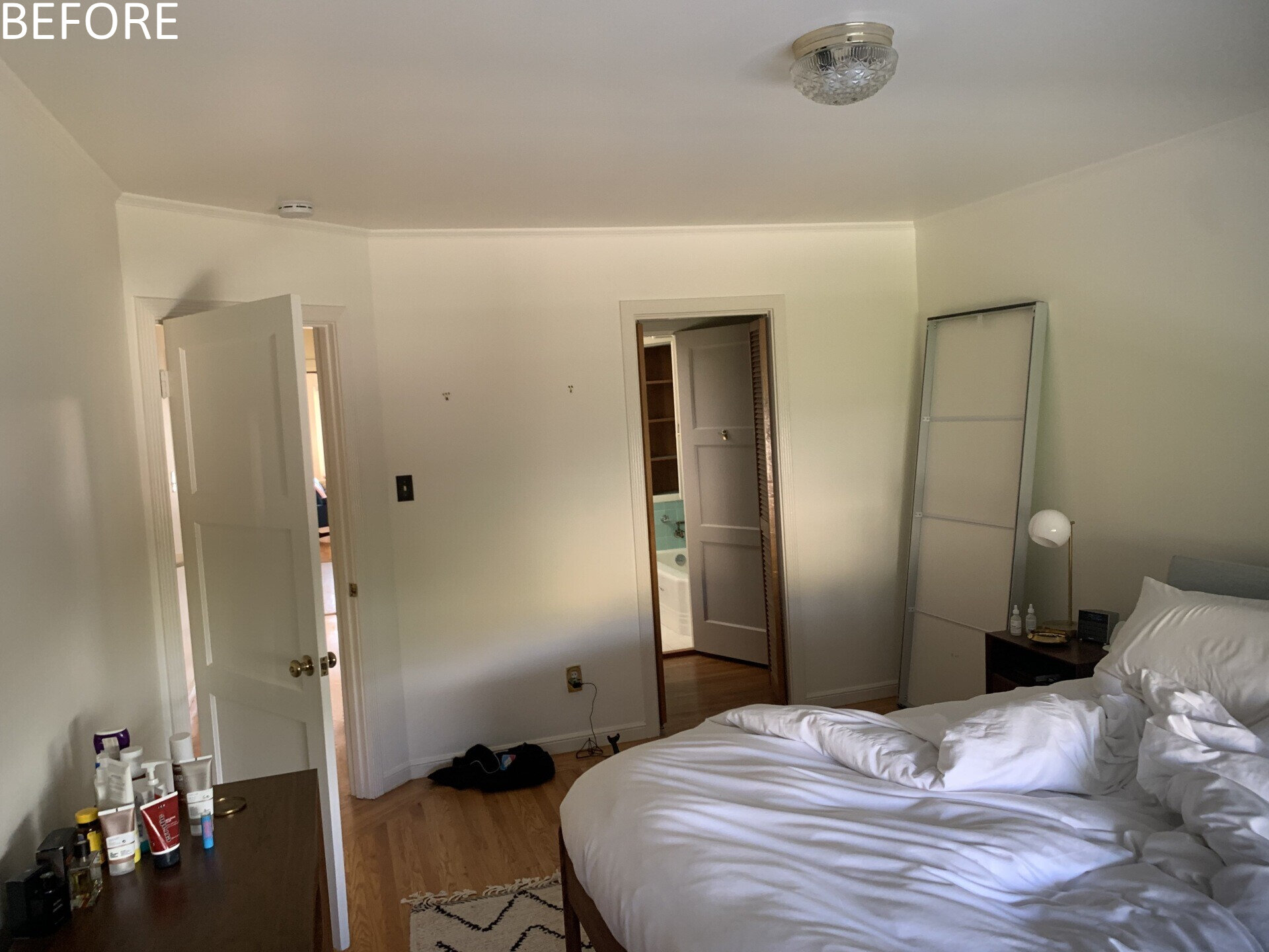 Like many older homes, the bathrooms were previously dark and enclosed. Natural light was minimal. The reconfigured main bathroom introduces a dramatic skylight directly over the shower. Dark gray tiles, slate flooring, and walnut cabinetry create contrast beneath the daylight above.