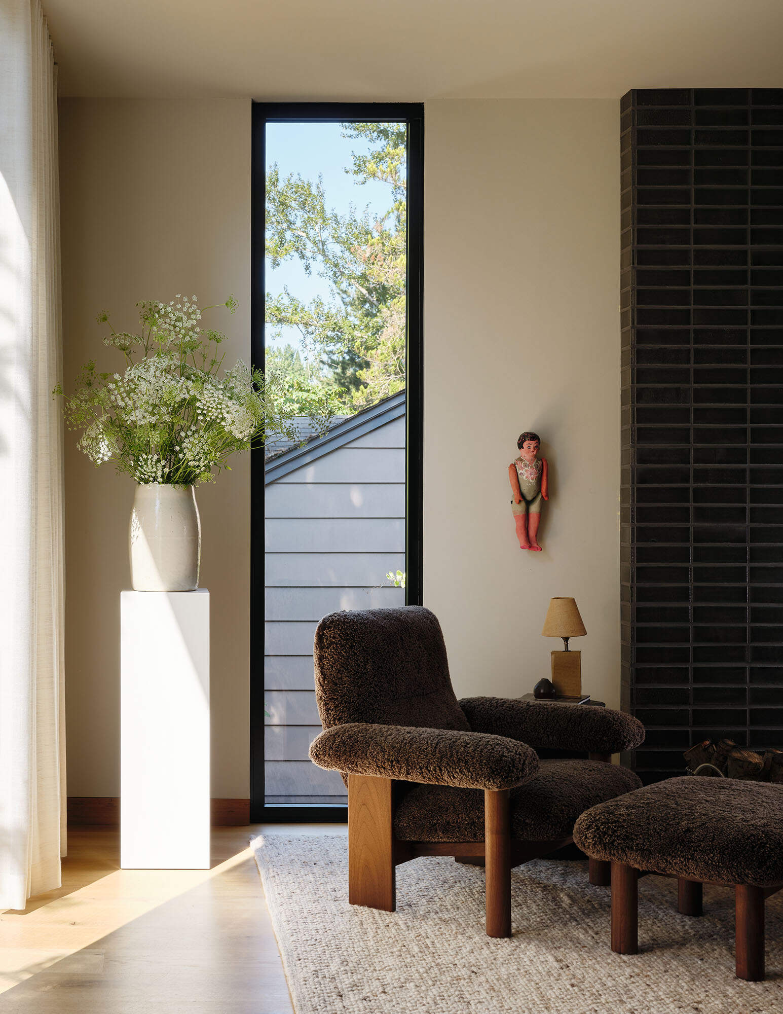 Large sliding glass doors blur the line between inside and out, connecting the living spaces to a calm central garden court.