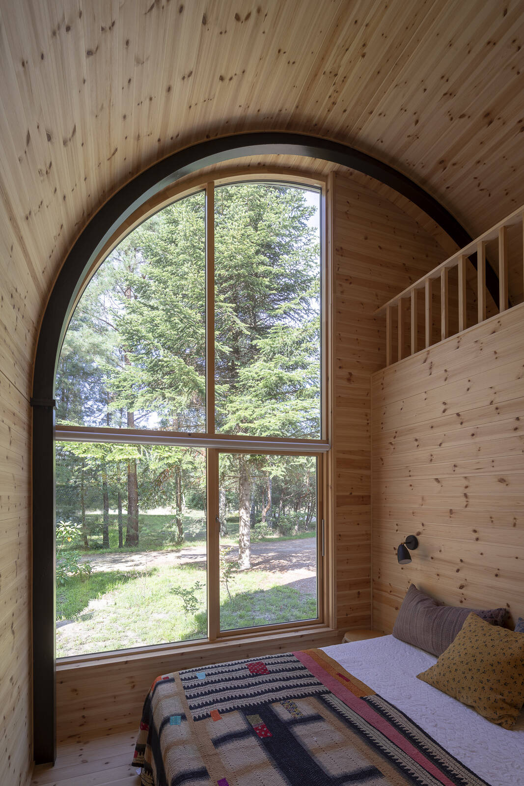 Three bedrooms and a bathroom with outdoor bathing facilities complete this forest summer house near Kattegat, designed to connect indoor living with nature.