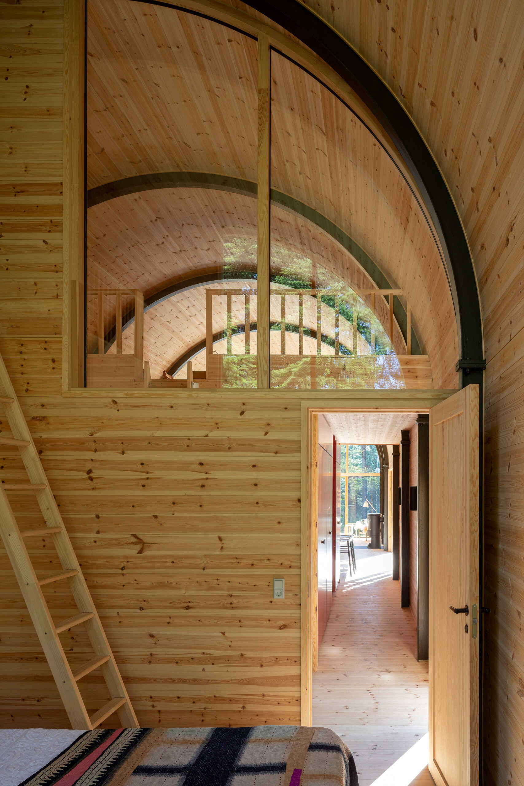 Three bedrooms and a bathroom with outdoor bathing facilities complete this forest summer house near Kattegat, designed to connect indoor living with nature.