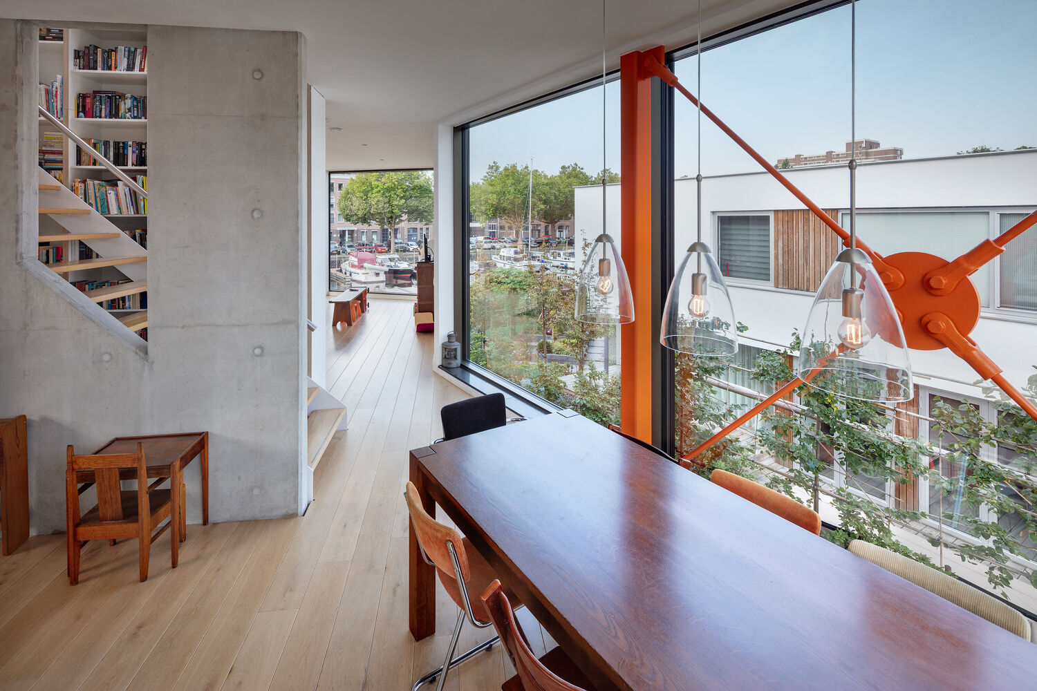 The rotated middle floor creates unexpected sightlines through the home. Panoramic glazing draws in treetops and water, turning the interior into a light filled, widescreen living space.